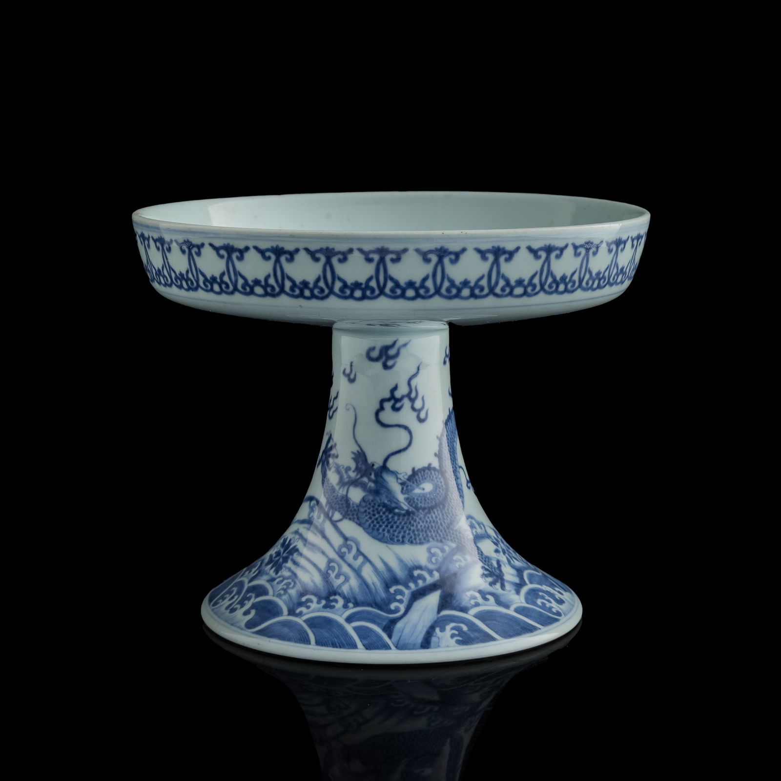 A Chinese blue and white stem plate, Qianlong period, Qing dynasty: A Chinese blue and white stem plate Qianlong period, Qing dynasty Finely painted with the carp-transforming-into-dragon motif rising amid turbulent waves, the creature shown in mid-metamorphosis.The i