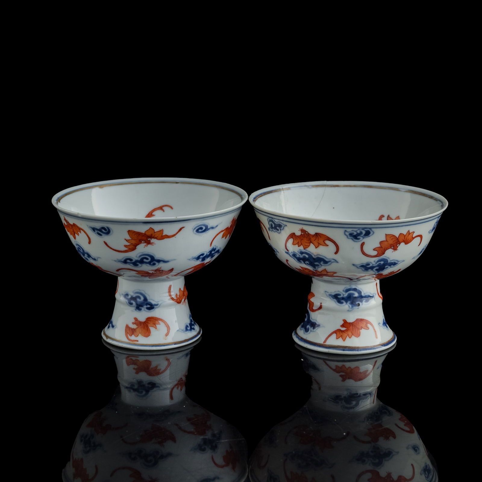 A pair of Chinese blue and enamel 'cloud and bat' stem bowls, 19th century: A pair of Chinese blue and enamel 'cloud and bat' stem bowls 19th century H: 4 1/8, Dia: 5 5/8 in. (H: 10.5, Dia: 14.3 cm. (each)) Private collection, Malvern, Pennsylvania.