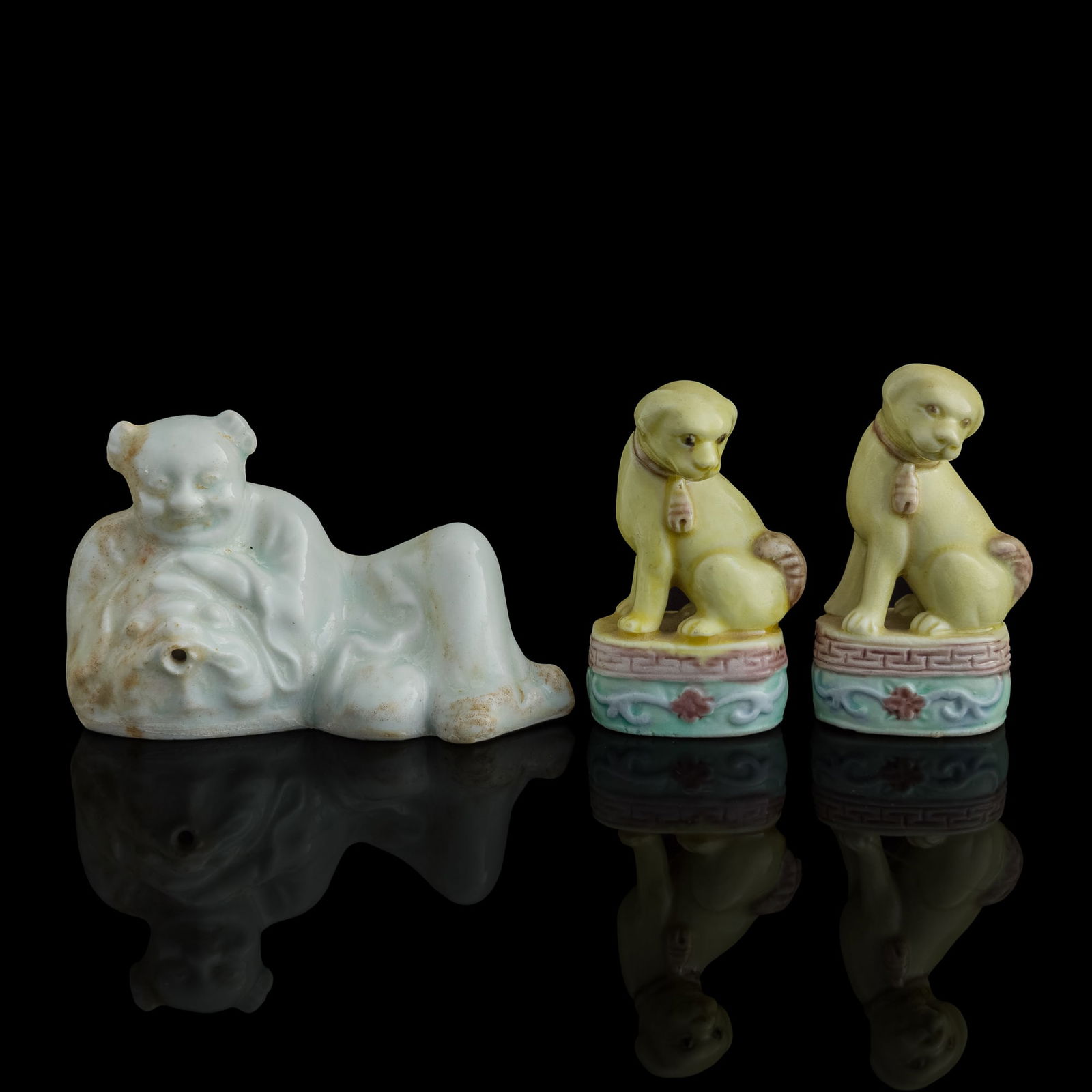 A pair of Chinese yellow-glazed dogs and a Qingbai-glazed boy, Qing dynasty (1 of 8)