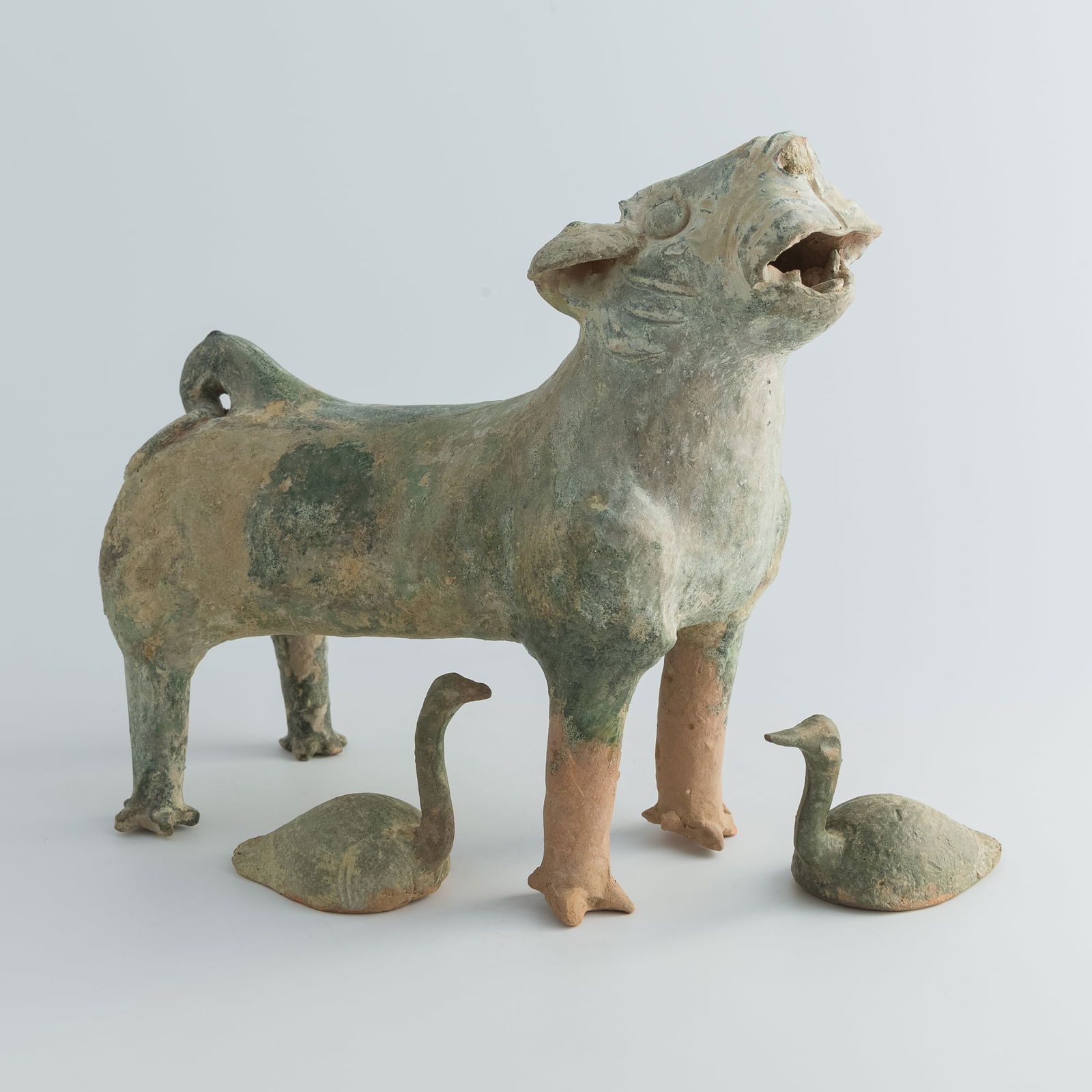 A Chinese green-glazed pottery dog and a pair of geese, Han dynasty: A Chinese green-glazed pottery dog and a pair of geeseHan dynastyH: 11 1/4, W: 5 1/4, D: 12 1/4 in. (H: 28.6, W: 13.3, D: 31.1 cm. (dog))From Dr. Lau, Honolulu, Hawaii. Acquired in Hong Kong in the