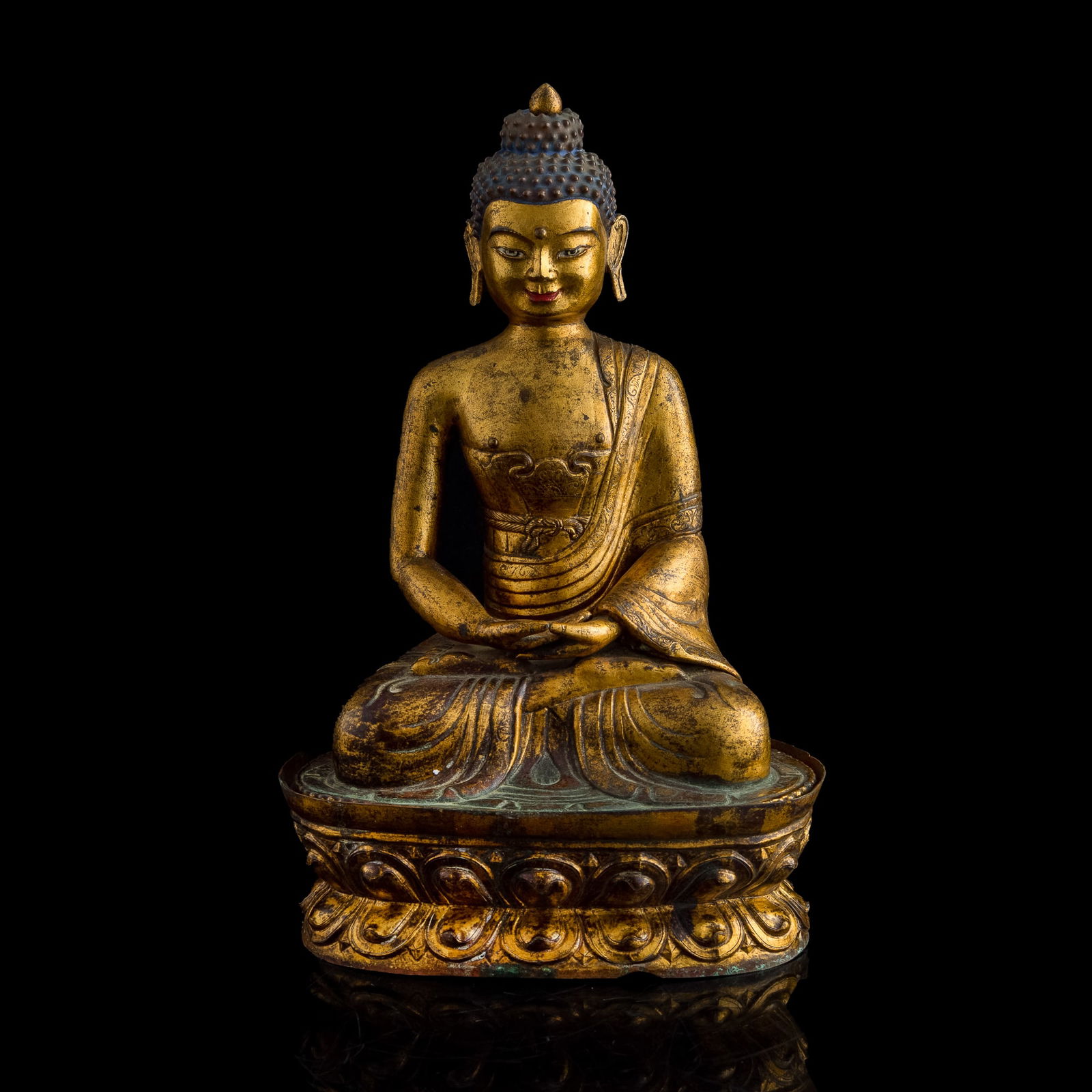 A Chinese gilt-bronze figure of Amitayus Buddha, 18th century: A Chinese gilt-bronze figure of Amitayus Buddha18th centurySeated in dhyanasana on a lotus base, with hands held in meditation gesture and the serene face framed by tightly curled hair and elongated