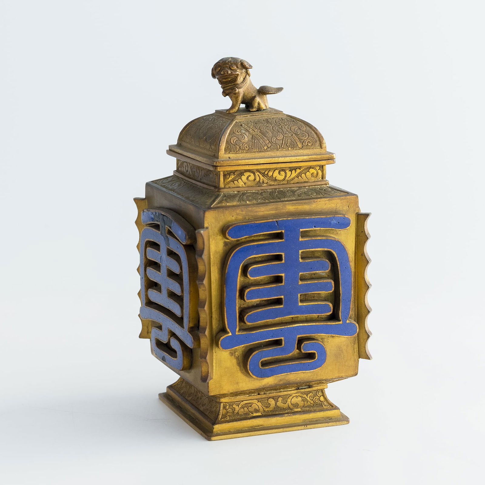 A Chinese gilt-bronze covered jar with lion finial, late 18th century: A Chinese gilt-bronze covered jar with lion finiallate 18th centuryH: 6, W: 3, D: 3 in. (H: 15.2, W: 7.6, D: 7.6 cm.)Weight: 657.9 gFrom an estate in San Diego, California.Click here for high