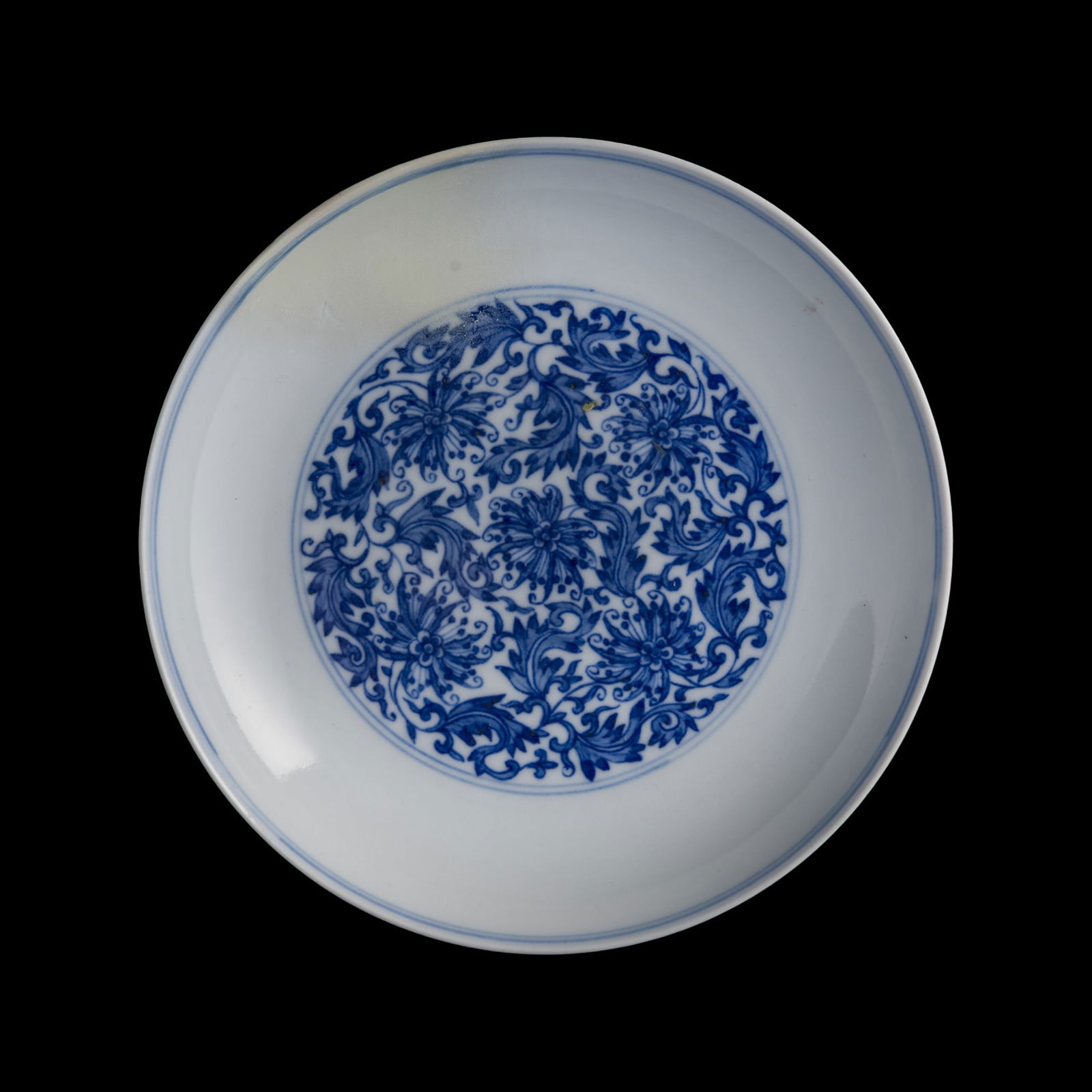 A Chinese blue and white 'scrolling lotus' plate, Yongzheng period, Qing dynasty (1 of 7)