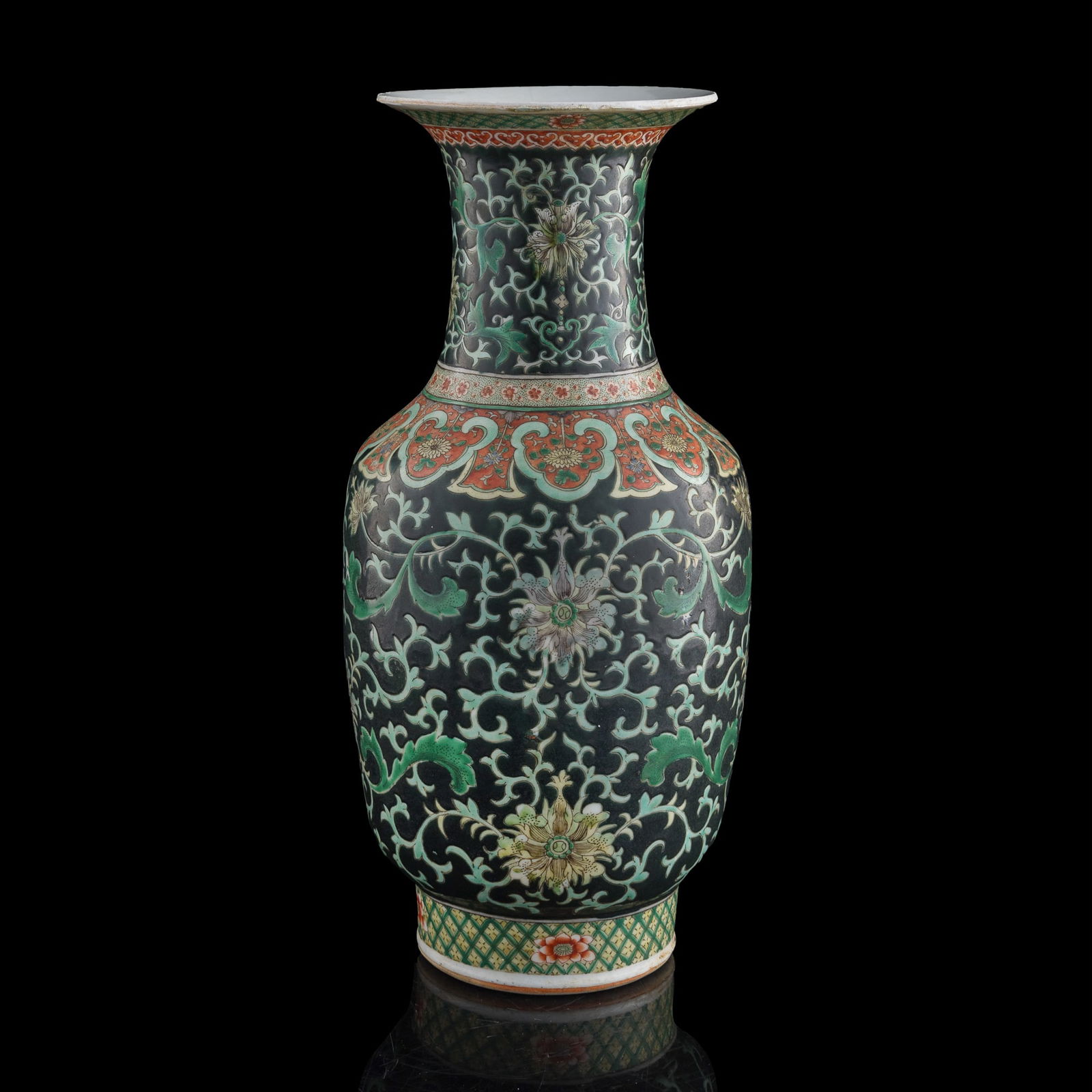 A Chinese black-ground sancai 'lotus scroll' vase, 19th century: A Chinese black-ground sancai 'lotus scroll' vase 19th century H: 17 3/4, Dia: 8 3/8 in. (H: 45.1, Dia: 21.3 cm.) Private collection, Malvern, Pennsylvania. Clic