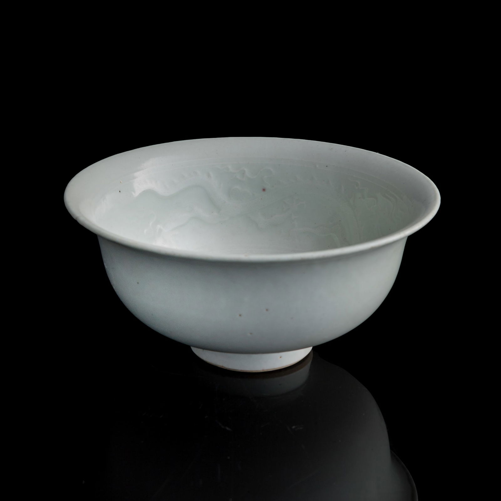 A Chinese white-glazed bowl with incised flowers, Yuan dynasty or later (1 of 8)