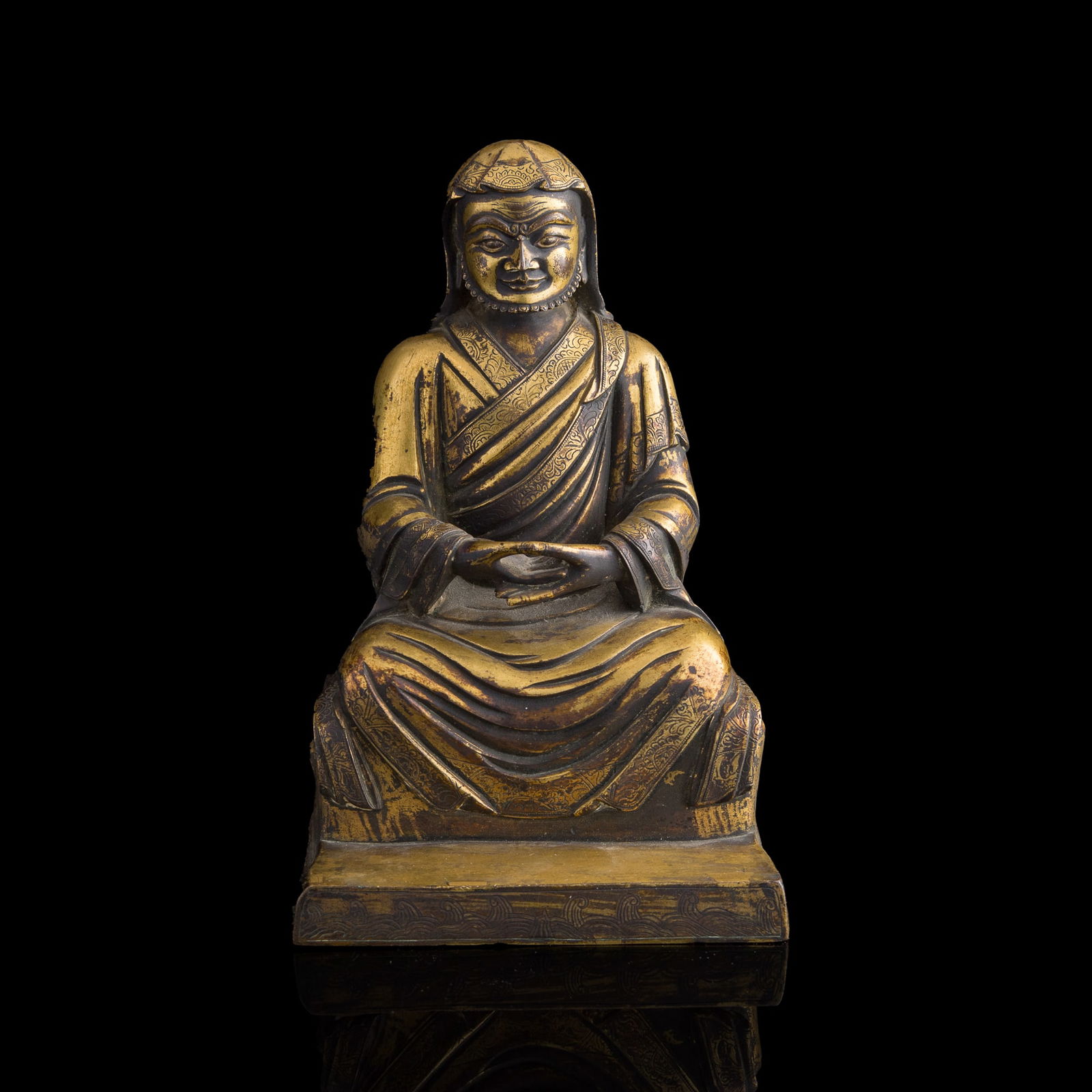 A Chinese gilt-bronze figure of a Buddhist master, 17th/18th century (1 of 9)