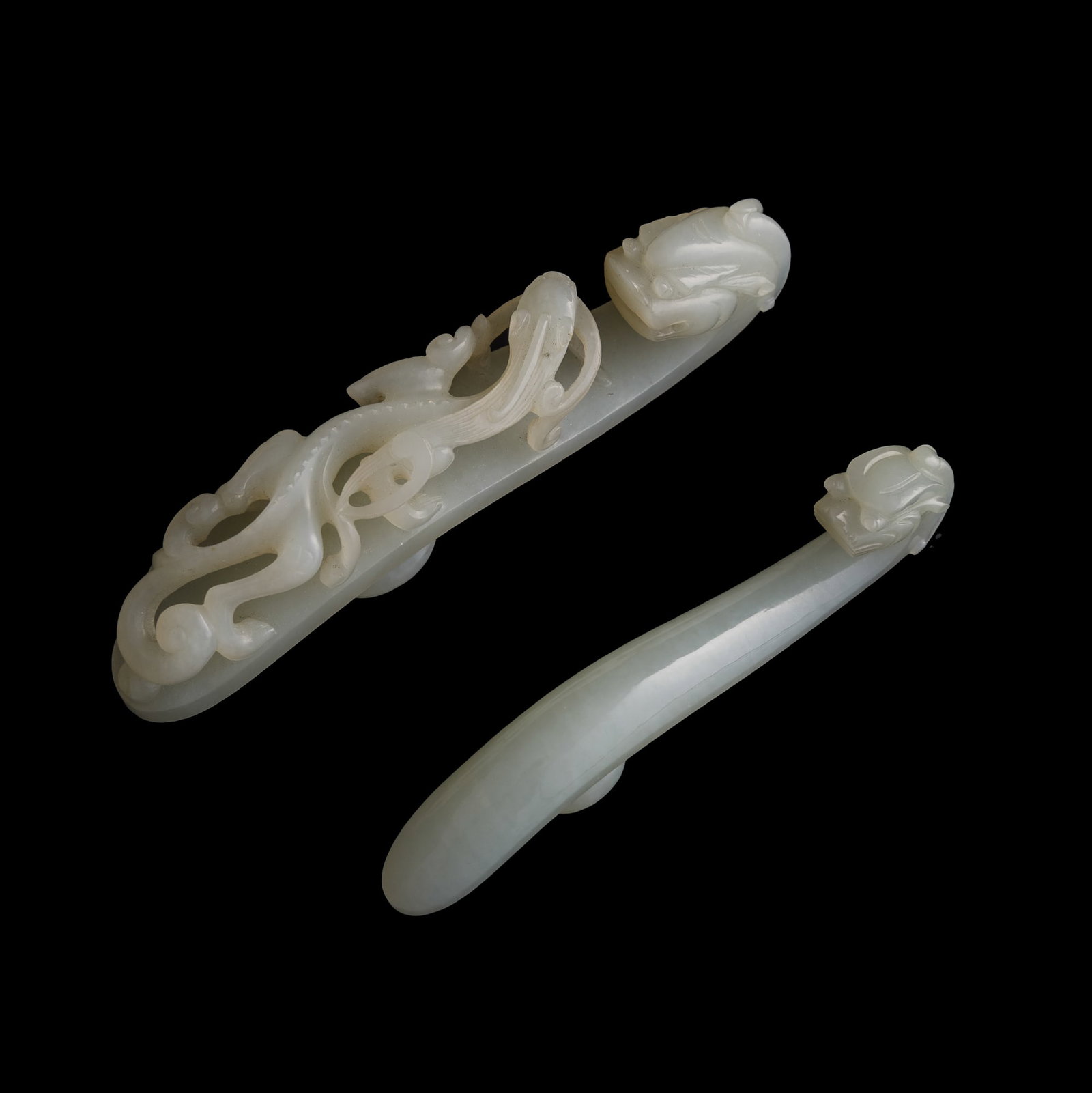 Two Chinese white jade dragon hooks, Qing dynasty: Two Chinese white jade dragon hooks Qing dynasty H: 4 1/2, W: 7/8, D: 1 1/8 in. (H: 11.4, W: 2.2, D: 2.9 cm. (largest)) Private collection, New Jersey.
