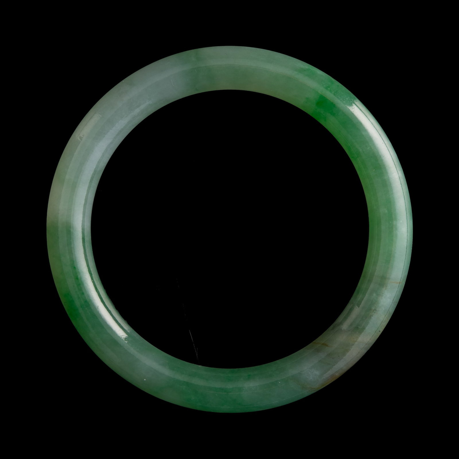 A Chinese jadeite bangle, Qing dynasty (1 of 6)