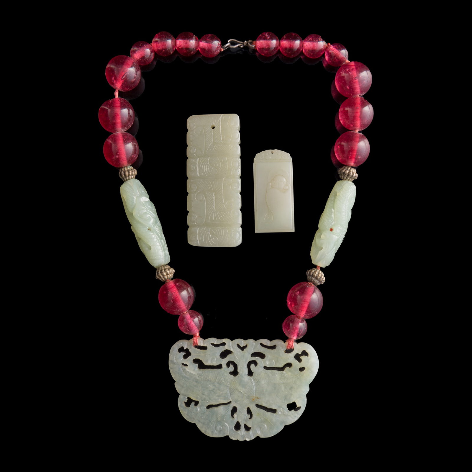 A Chinese glass and jade necklace and two jade plaques, Qing dynasty or later: A Chinese glass and jade necklace and two jade plaques Qing dynasty or later Necklace length: 11 in. (27.9 cm.); Butterfly: H: 2 1/8, W: 3 1/4, D: 1/8 in. (H: 5.4, W: 8.3, D: 0.3 cm.) Private collecti