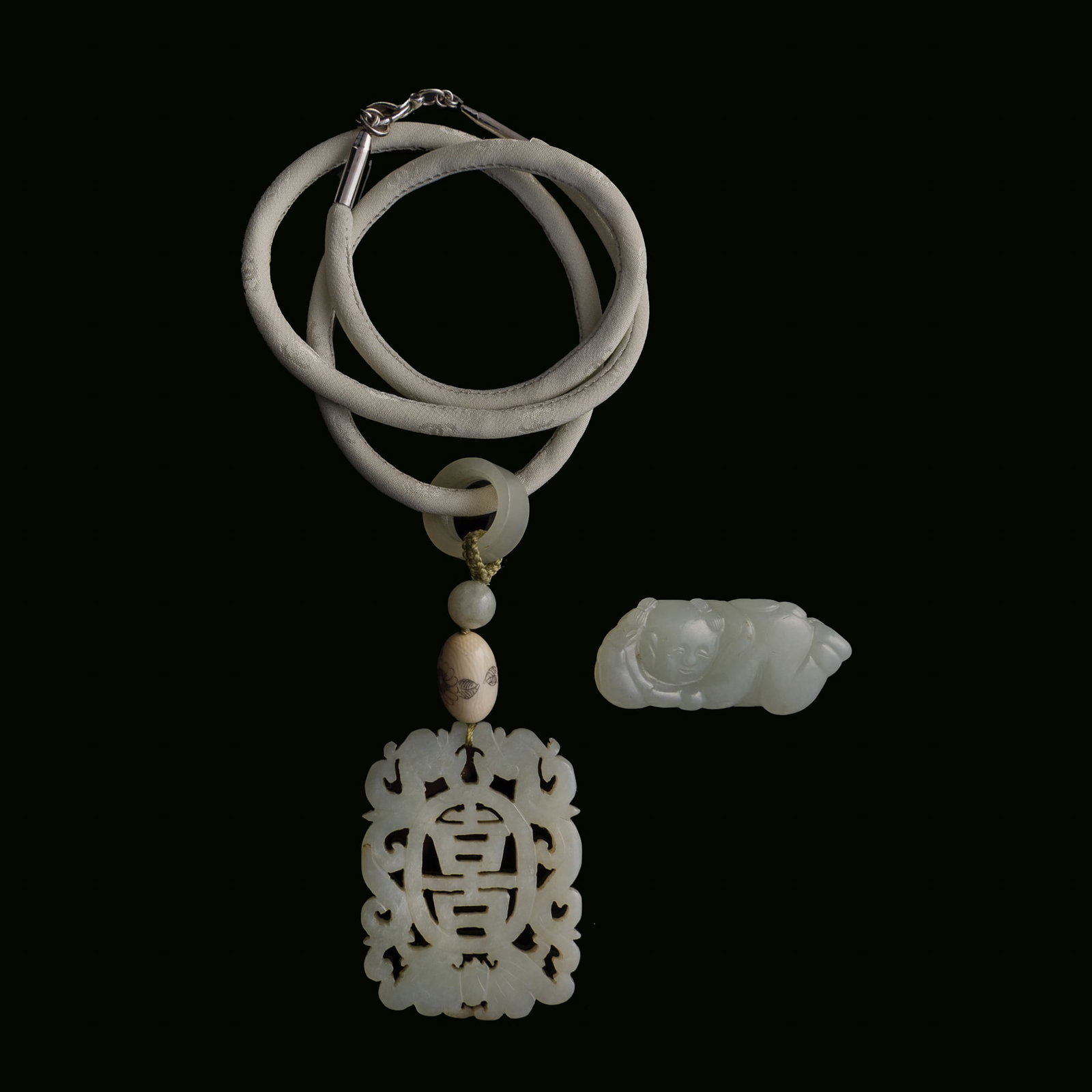 A Chinese jade toggle and a reticulated jade plaque, 19th century (1 of 7)