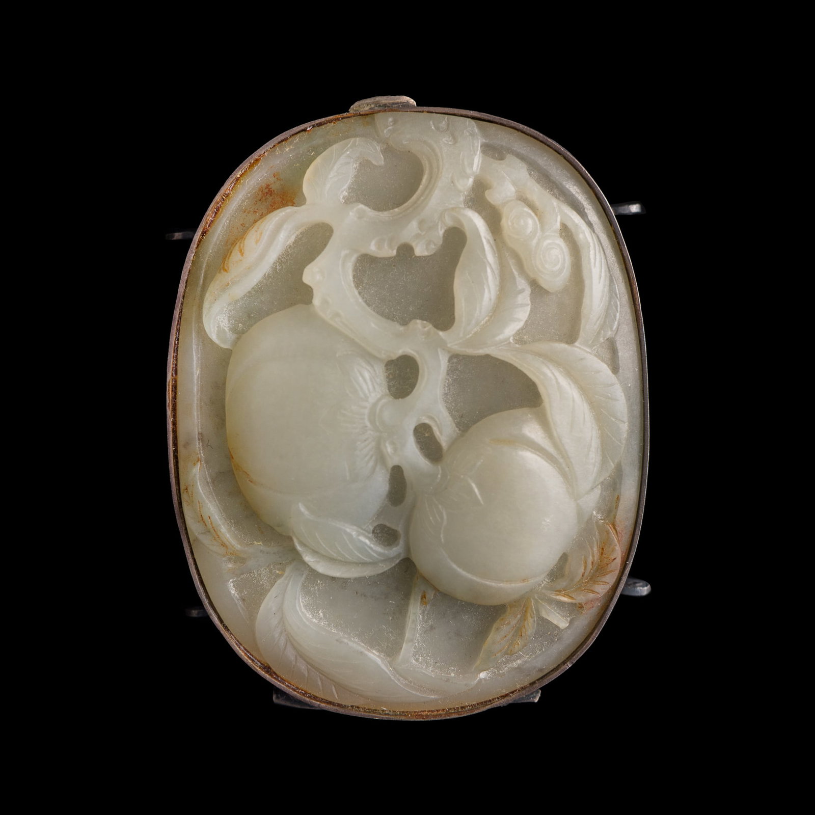 A Chinese carved white jade ‘longevity peach’ plaque, 18th century: A Chinese carved white jade ‘longevity peach’ plaque 18th century With an affixed silver mount. H: 2, W: 2 1/2, D: 1 in. (H: 5.1, W: 6.4, D: 2.5 cm.) Private collection, Berkeley, California.