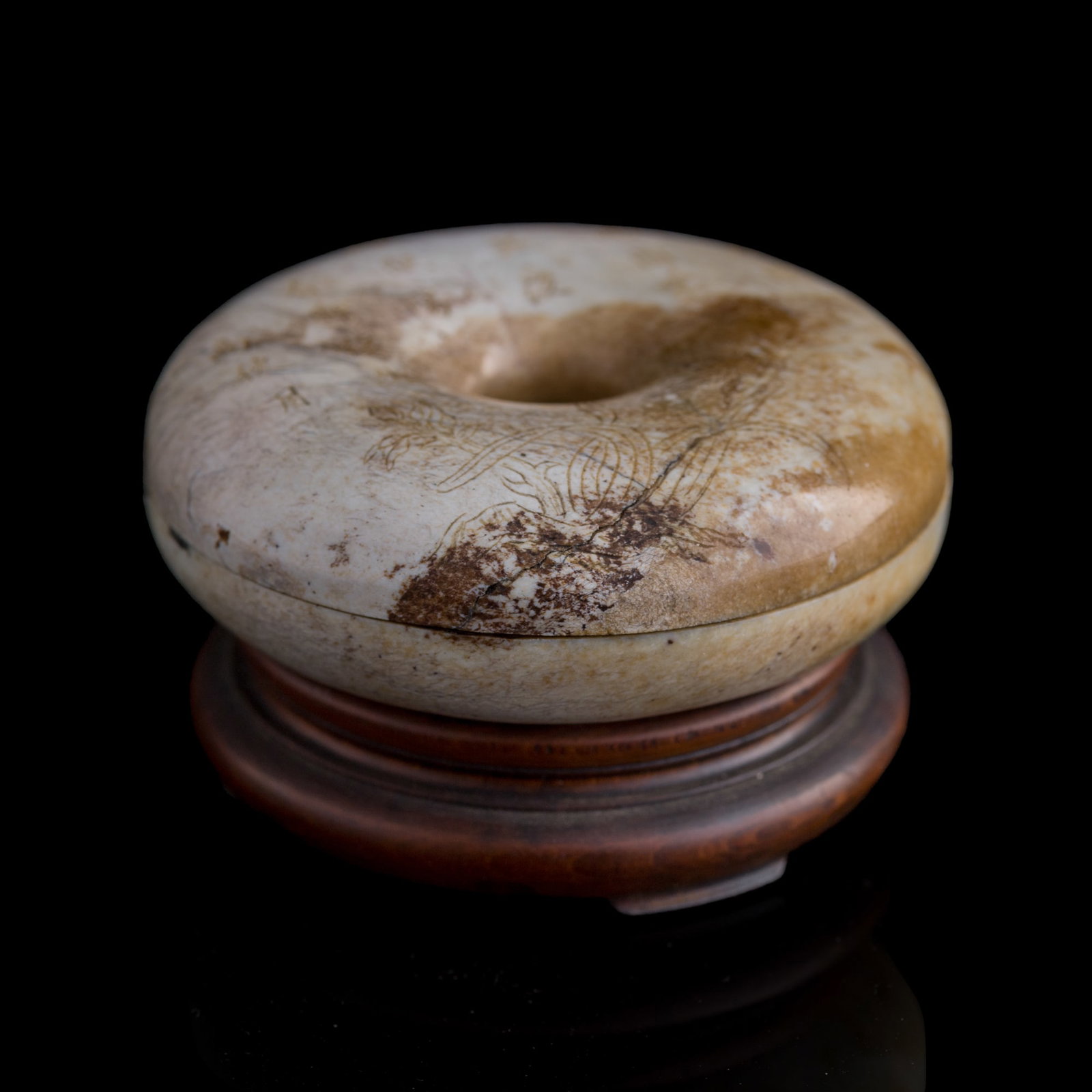 A Chinese heat-altered jade bracelet box, 18th century: A Chinese heat-altered jade bracelet box 18th century Carved with a poem and flowers to the top, a "made of Qianlong period" four-character mark to the underside. Sold with an original hardwood stand.