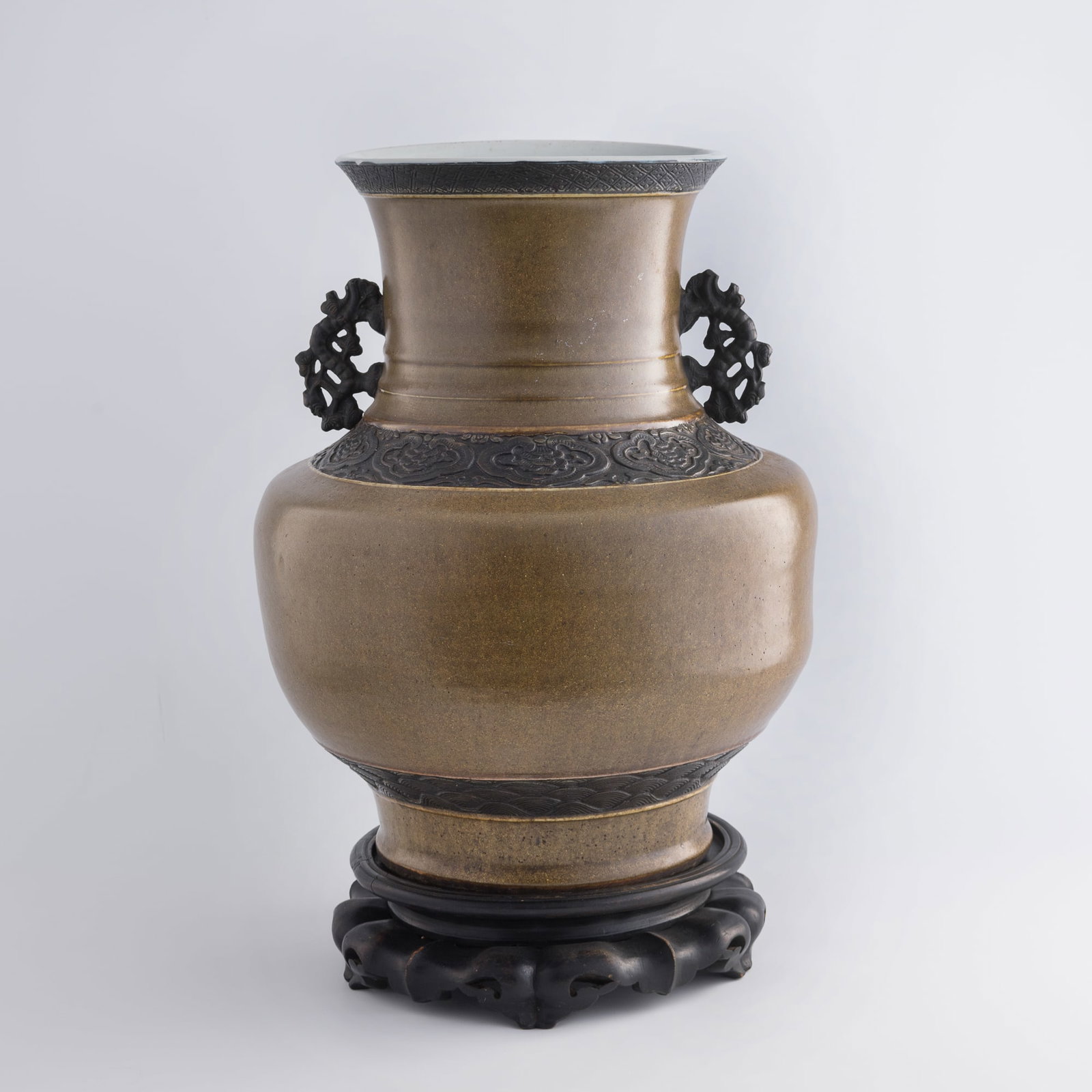 A Chinese tea-dust-glazed double-handled zun vase, early 19th century: A Chinese tea-dust-glazed double-handled zun vase early 19th century Sold with associated hardwood stand. H: 18 1/2, Dia: 15 in. (H: 47, Dia: 38.1 cm. (vase)) Private collection, Saratoga, California.