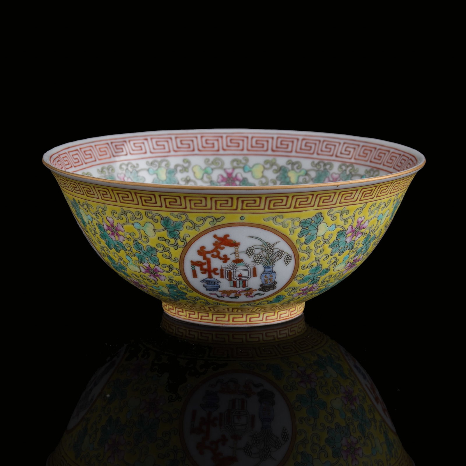 A Chinese yellow-ground famille rose 'hundred antiques' bowl, Guangxu period, Qing dynasty (1 of 9)