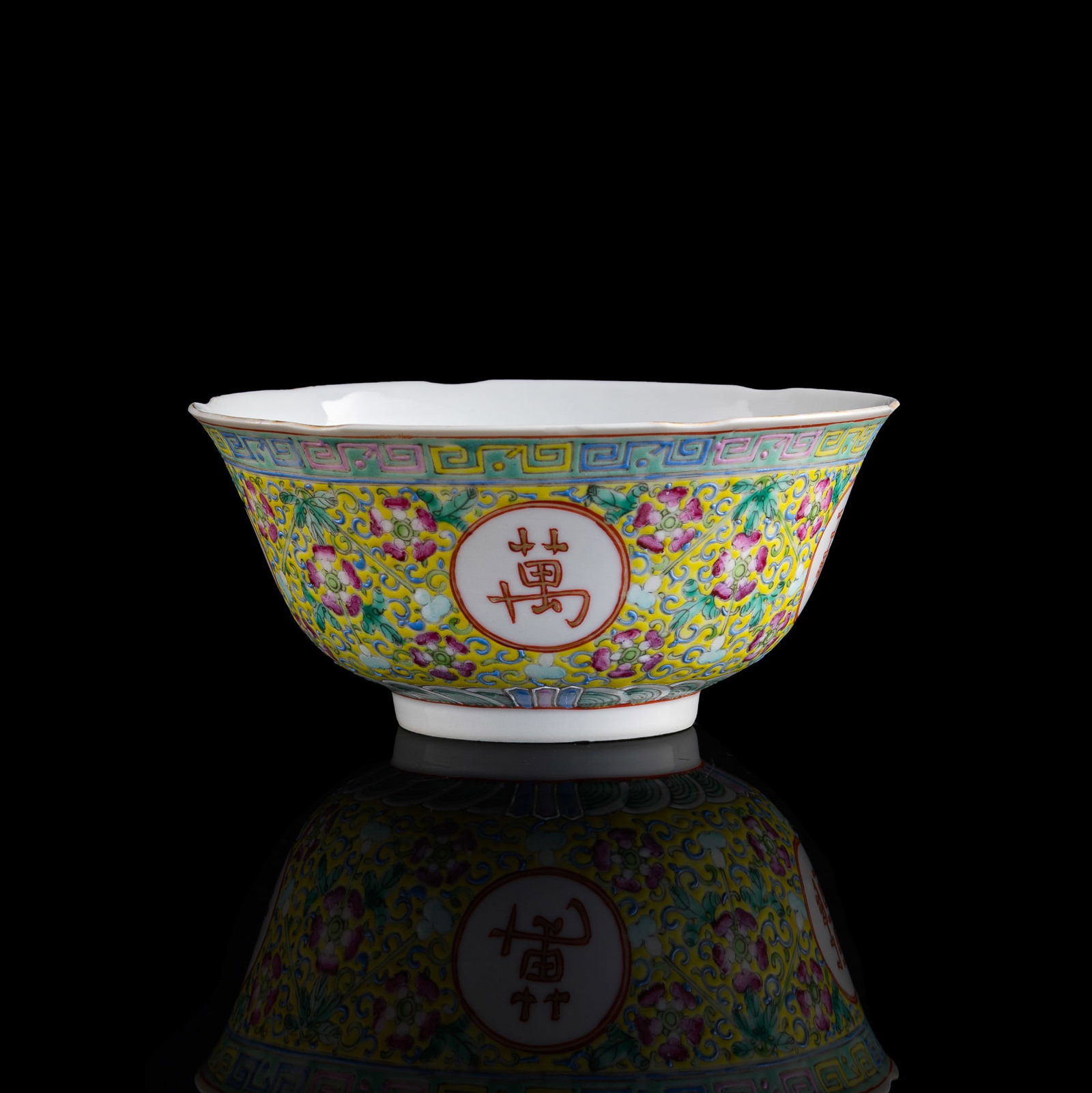 A Chinese yellow-ground famille rose 'shou' bowl, Guangxu period, Qing dynasty (1 of 9)