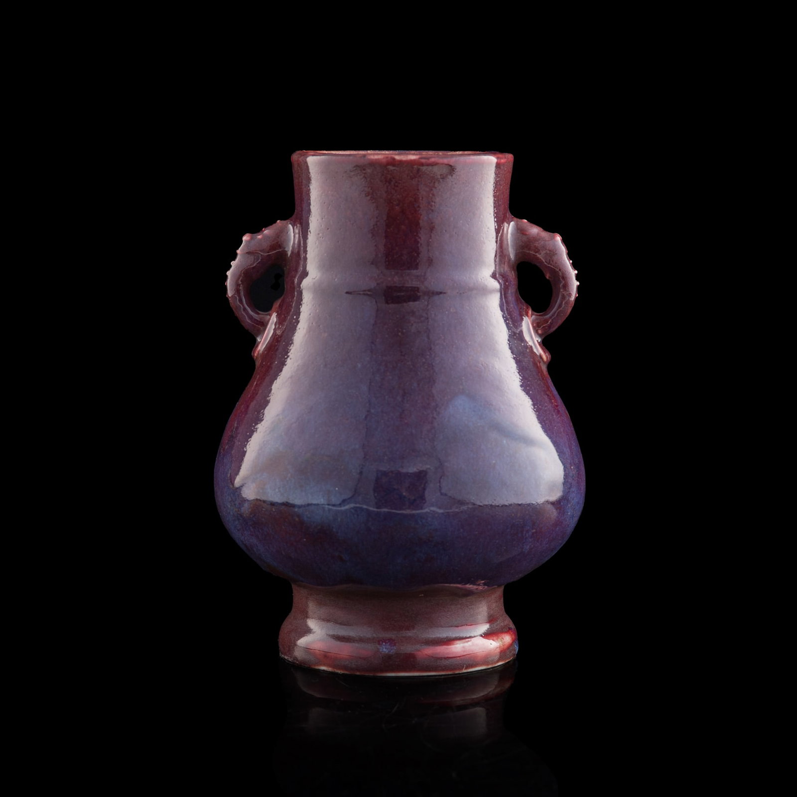 A Chinese flambe-glazed double-handled vase, late 19th century: A Chinese flambe-glazed double-handled vase late 19th century H: 10, Dia: 7 1/4 in. (H: 25.4, Dia: 18.4 cm.) Private collection, Rowland Heights, California. From Mrs. Chung, Chicago, Illinois; a fami