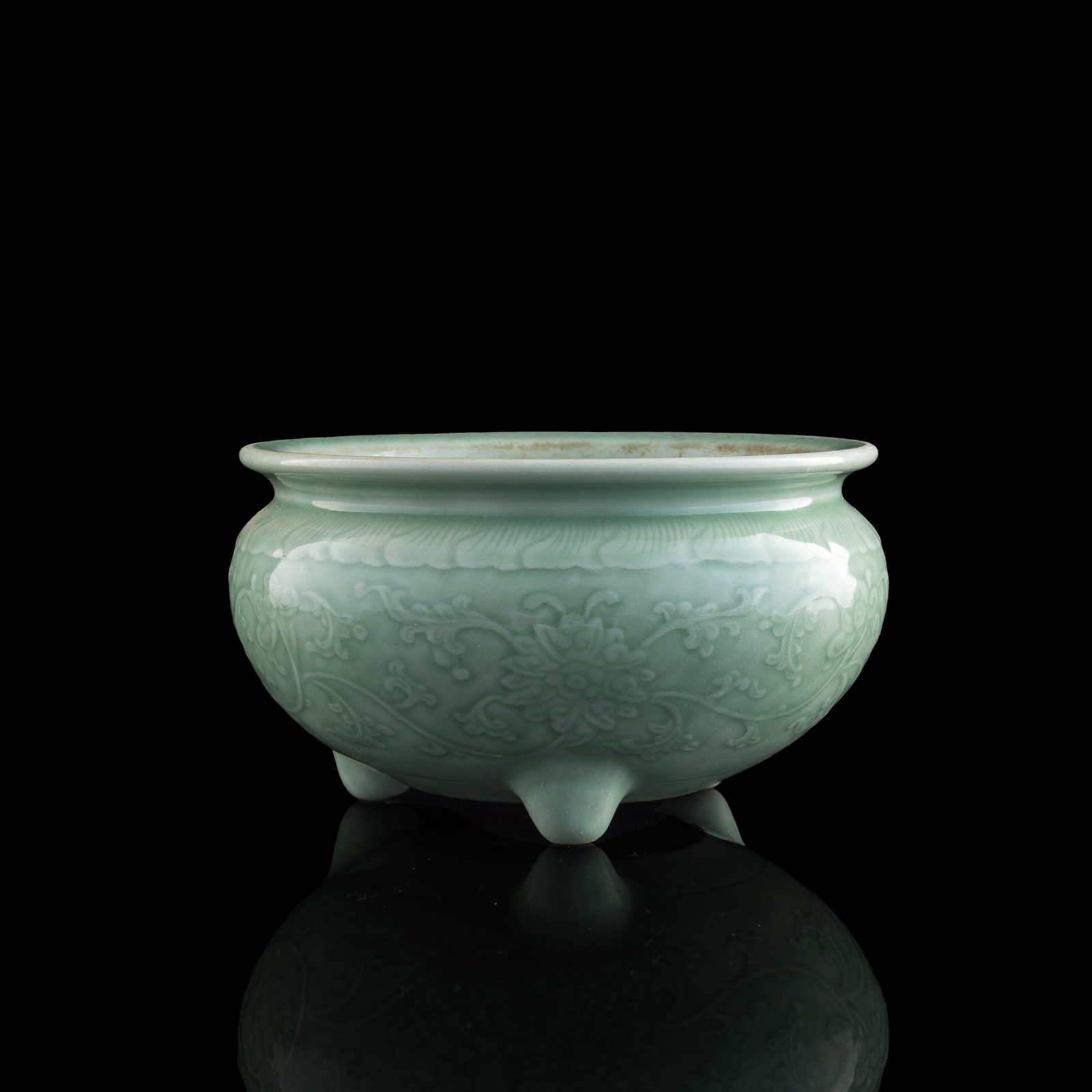 A Chinese celadon tripod 'floral' censer, late 18th century: A Chinese celadon tripod 'floral' censer late 18th century H: 5 3/8, Dia: 9 1/2 in. (H: 13.7, Dia: 24.1 cm.) Private collection, Rowland Heights, California. From the estate of Mr. David Wong, Honolul