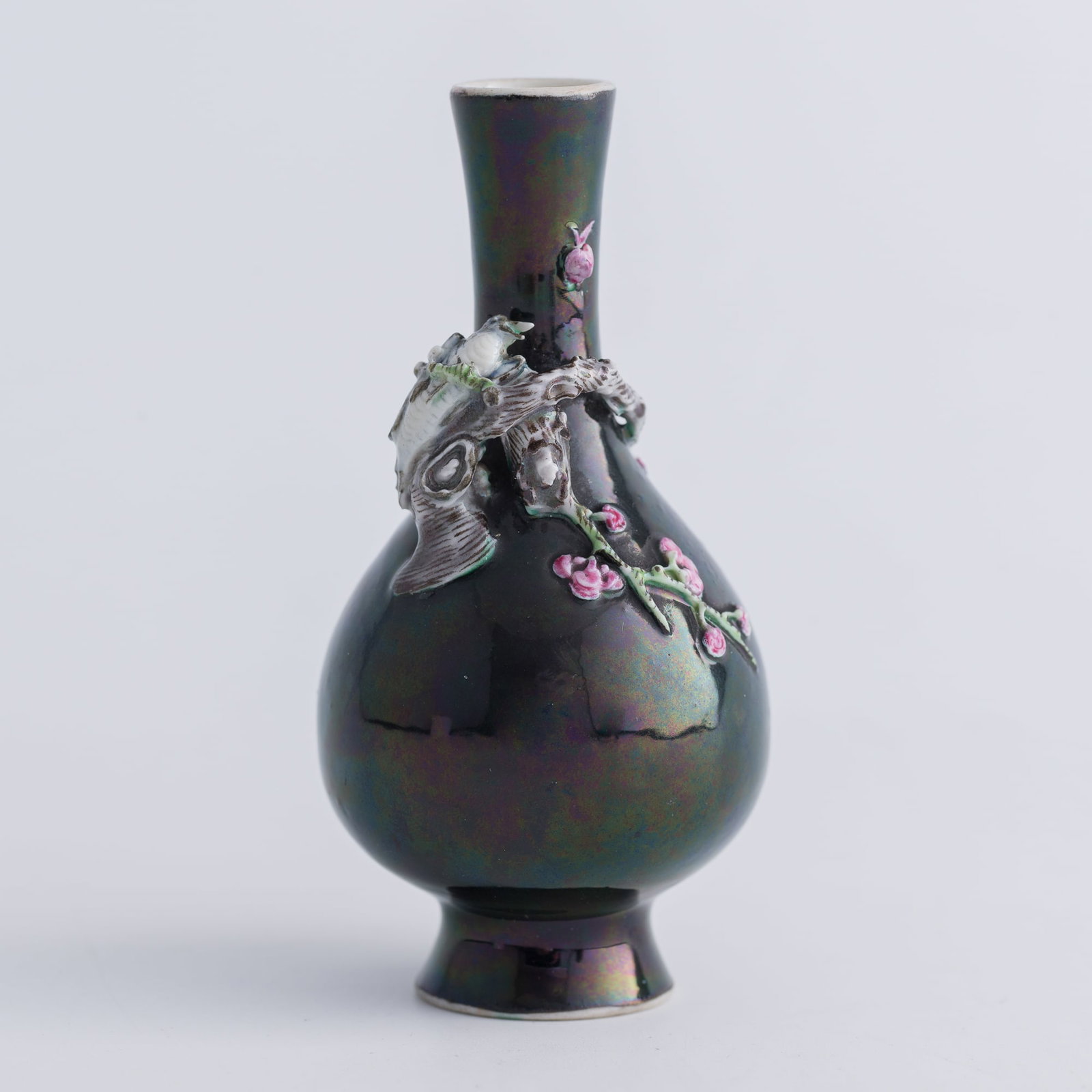 A Chinese black-ground famille rose carved porcelain miniature dan vase, late 19th century: A Chinese black-ground famille rose carved porcelain miniature dan vase late 19th century Carved with a magpie perched on a prunus branch. H: 3 3/4, Dia: 1 3/4 in. (H: 9.5, Dia: 4.4 cm.) Private colle