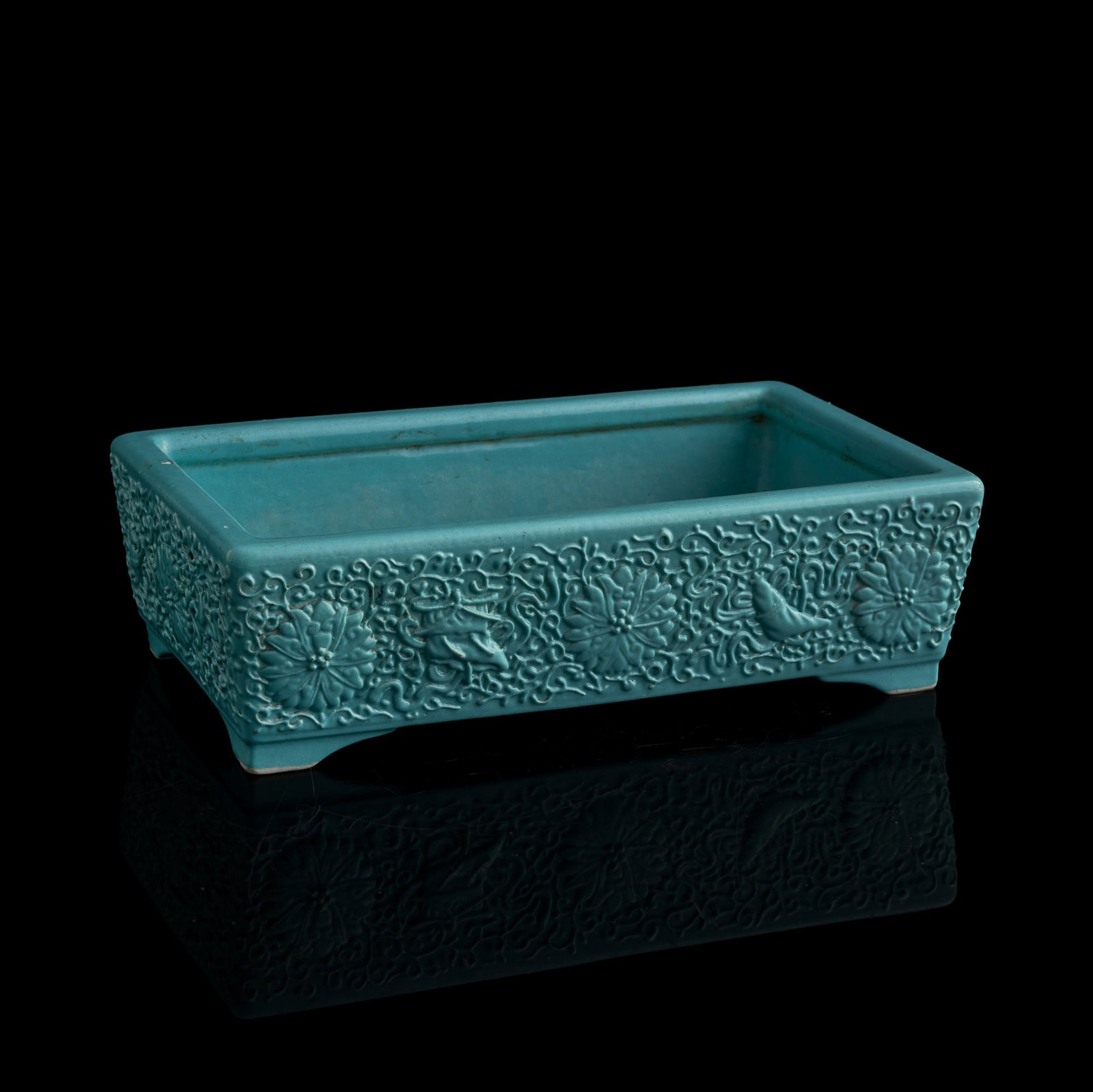 A Chinese turquoise-glazed 'lotus scrolls' narcissus bowl, 19th century: A Chinese turquoise-glazed 'lotus scrolls' narcissus bowl 19th century With six-character mark to underside. H: 2 7/8, W: 10, D: 5 3/4 in. (H: 7.3, W: 25.4, D: 14.6 cm.) Private collection, New York.