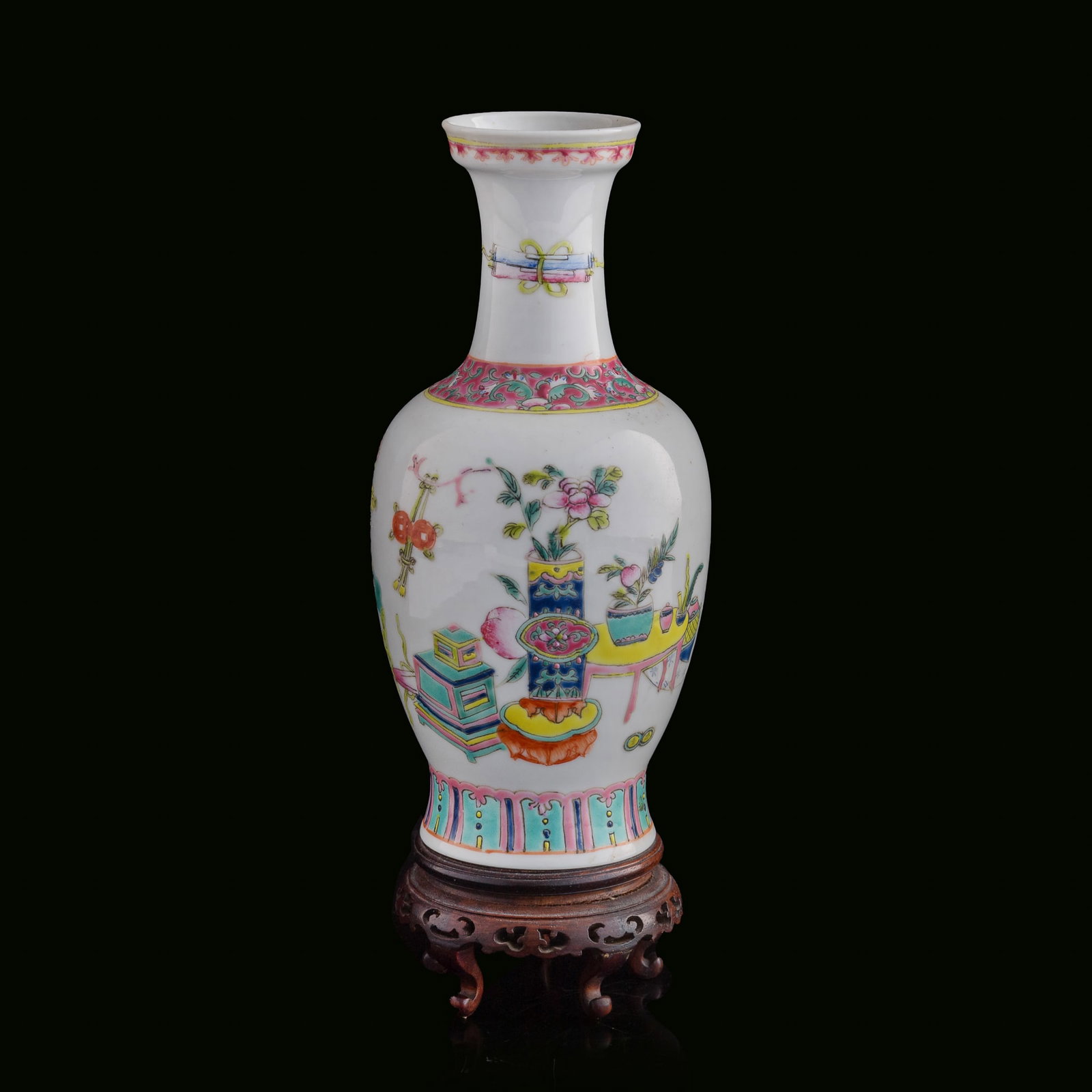 A Chinese famille rose 'hundred antiques' vase, Republic period: A Chinese famille rose 'hundred antiques' vase Republic period Sold with associated wooden stand. H: 8, Dia: 3 3/4 in. (H: 20.3, Dia: 9.5 cm. (vase)) Private collection, Saratoga, California.