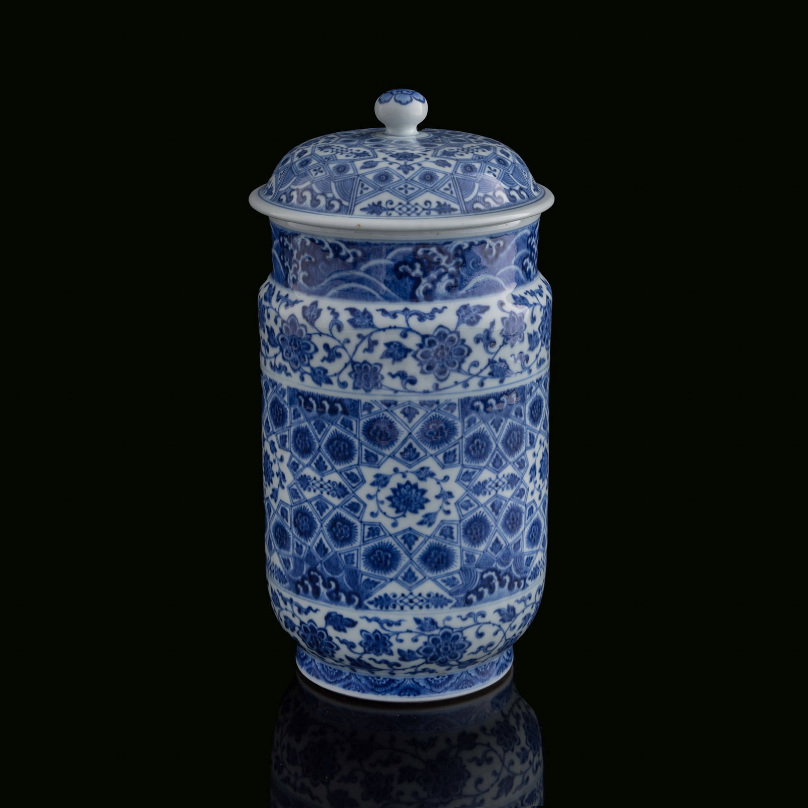 A Chinese blue and white 'scrolling flower' and 'ice-crack pattern' cylindrical jar, Qianlong: A Chinese blue and white 'scrolling flower' and 'ice-crack pattern' cylindrical jar Qianlong period, Qing dynasty The cylindrical body is painted in underglaze blue with bands of scrolling floral moti