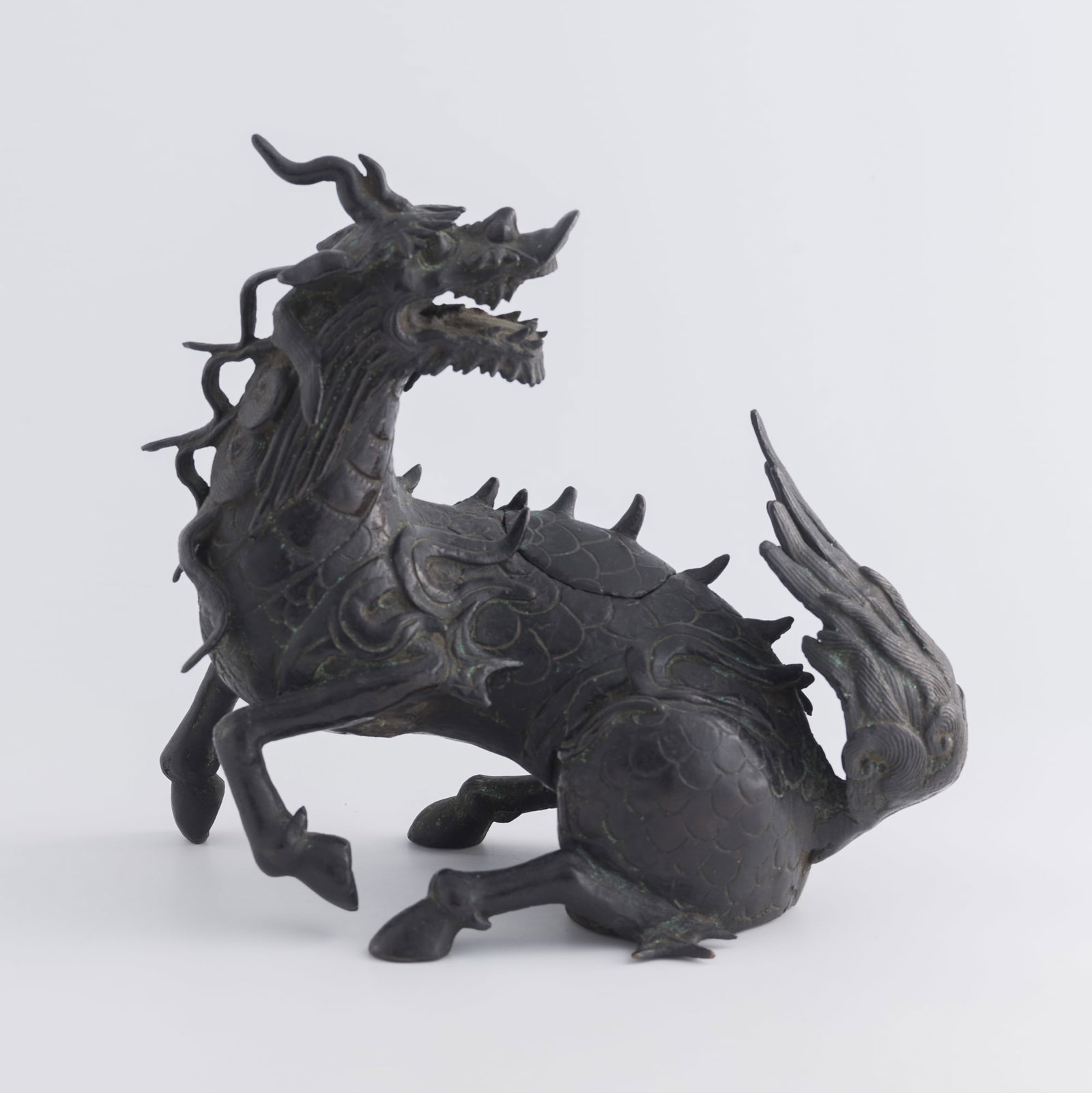 A Chinese bronze qilin-form incense burner, 18th century or earlier: A Chinese bronze qilin-form incense burner 18th century or earlier H: 8 7/8, W: 9 1/2, D: 5 in. (H: 22.5, W: 24.1, D: 12.7 cm.) Weight: 3150 g Private collection, New Jersey.