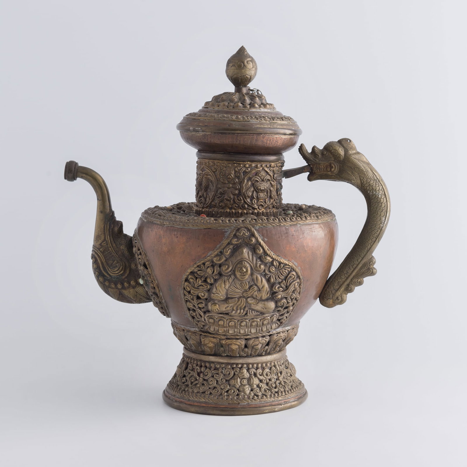 A Tibetan copper ewer inset with turquoise and coral, Qing dynasty: A Tibetan copper ewer inset with turquoise and coral Qing dynasty H: 12 3/4, W: 11 3/4, D: 7 1/2 in. (H: 32.4, W: 29.8, D: 19.1 cm.) Weight: 1851 g Private collection, New Jersey.