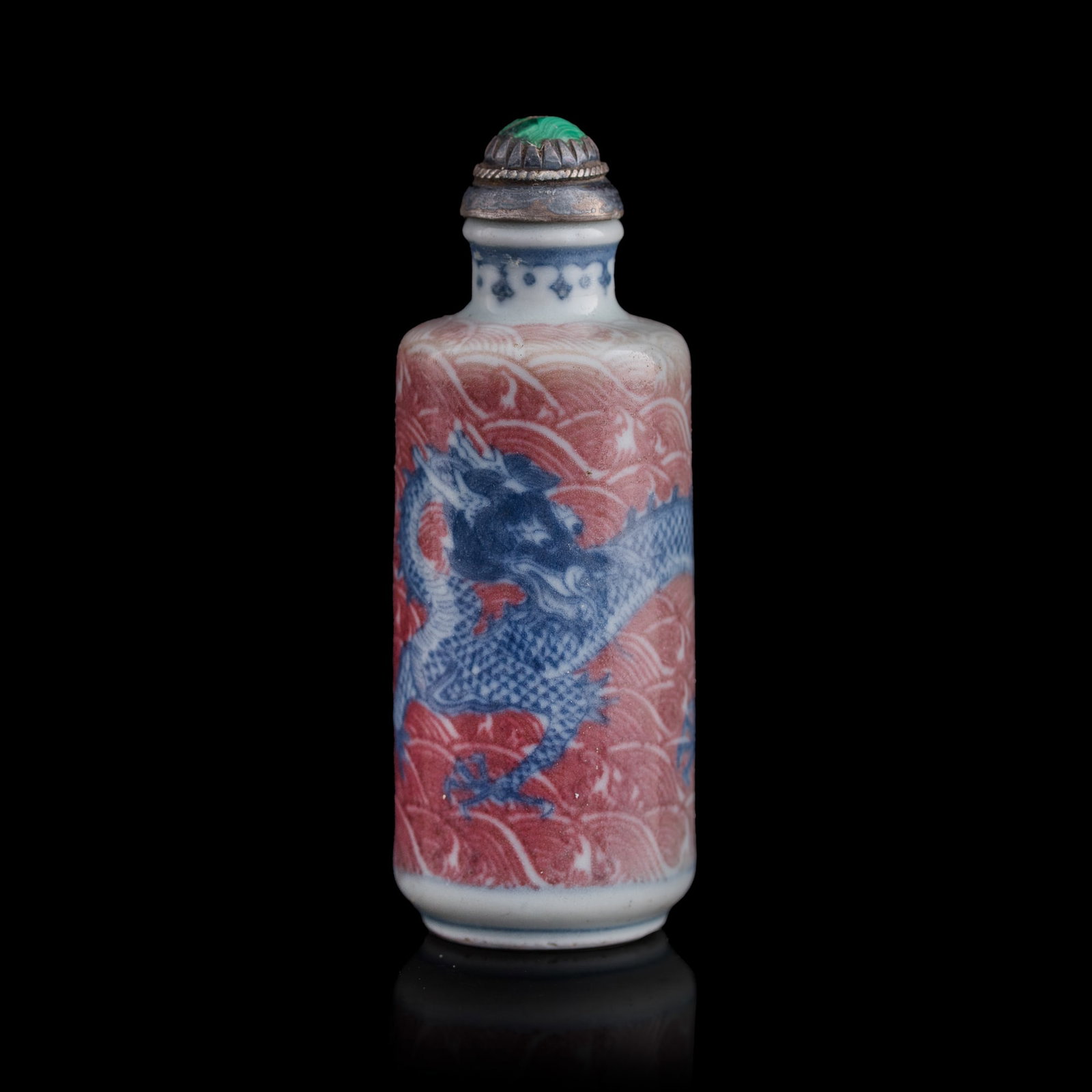 A Chinese blue and copper-red-underglazed ‘dragon’ snuff bottle, 19th century: A Chinese blue and copper-red-underglazed ‘dragon’ snuff bottle 19th century H: 3 1/4, Dia: 1 1/4 in. (H: 8.3, Dia: 3.2 cm.) From Mr. Tinero, Calabasas, California; acquired by his father in Hong 