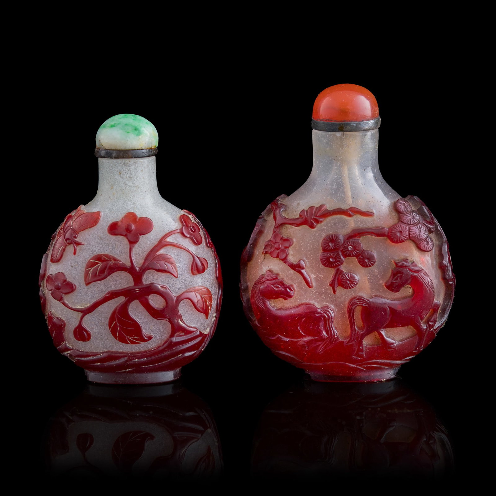 Two Chinese red-overlay white glass snuff bottles, 19th century: Two Chinese red-overlay white glass snuff bottles 19th century H: 2 3/4, W: 2, D: 1 in. (H: 7, W: 5.1, D: 2.5 cm. (largest)) From Mr. Tinero, Calabasas, California; acquired by his father in Hong Kong