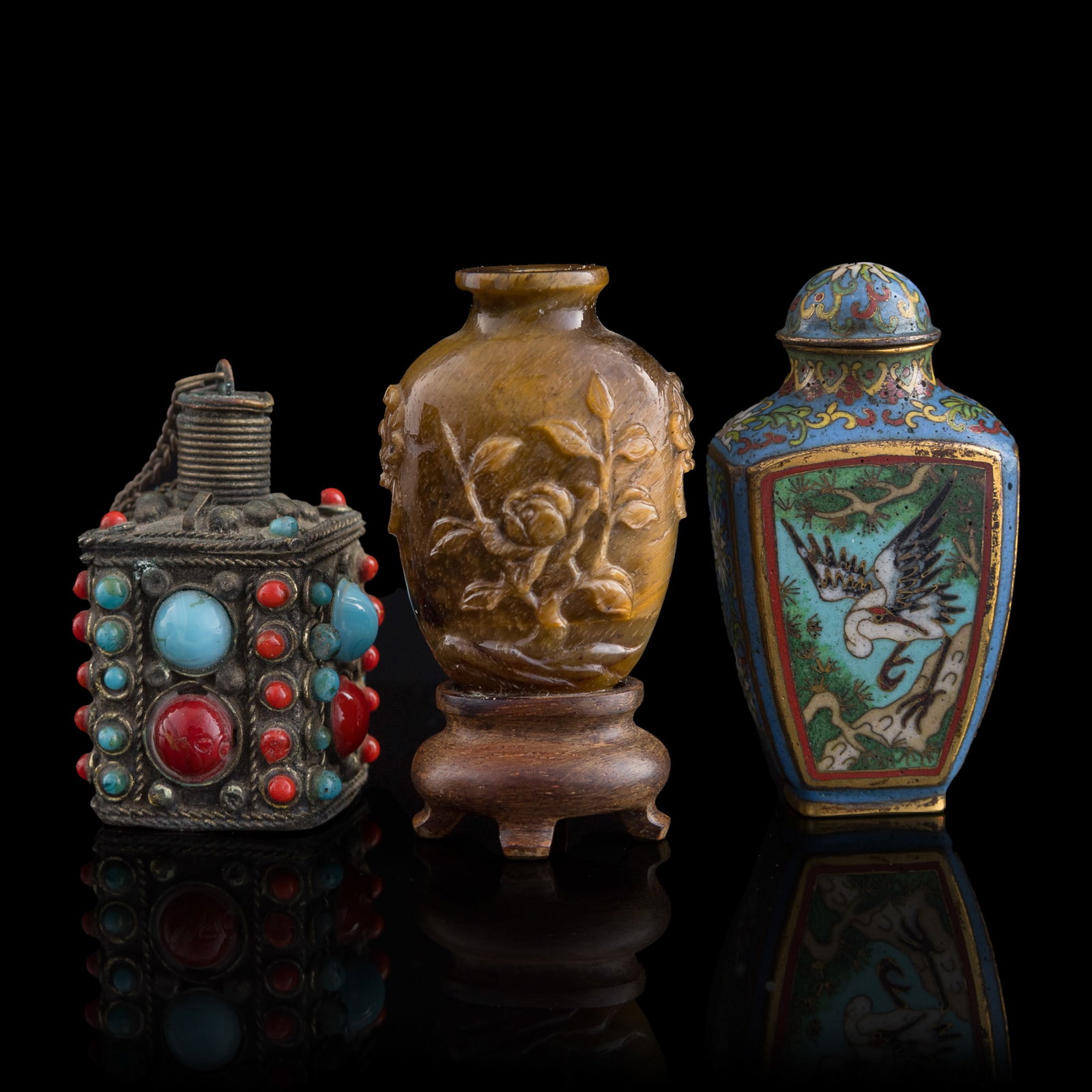 Three assorted Chinese snuff bottles, early 20th century: Three assorted Chinese snuff bottles early 20th century Sold with one associated wooden stand. (3). H: 2 1/2, W: 1 3/8, D: 1 in. (H: 6.4, W: 3.5, D: 2.5 cm. (largest)) Private collection, Southern Cal
