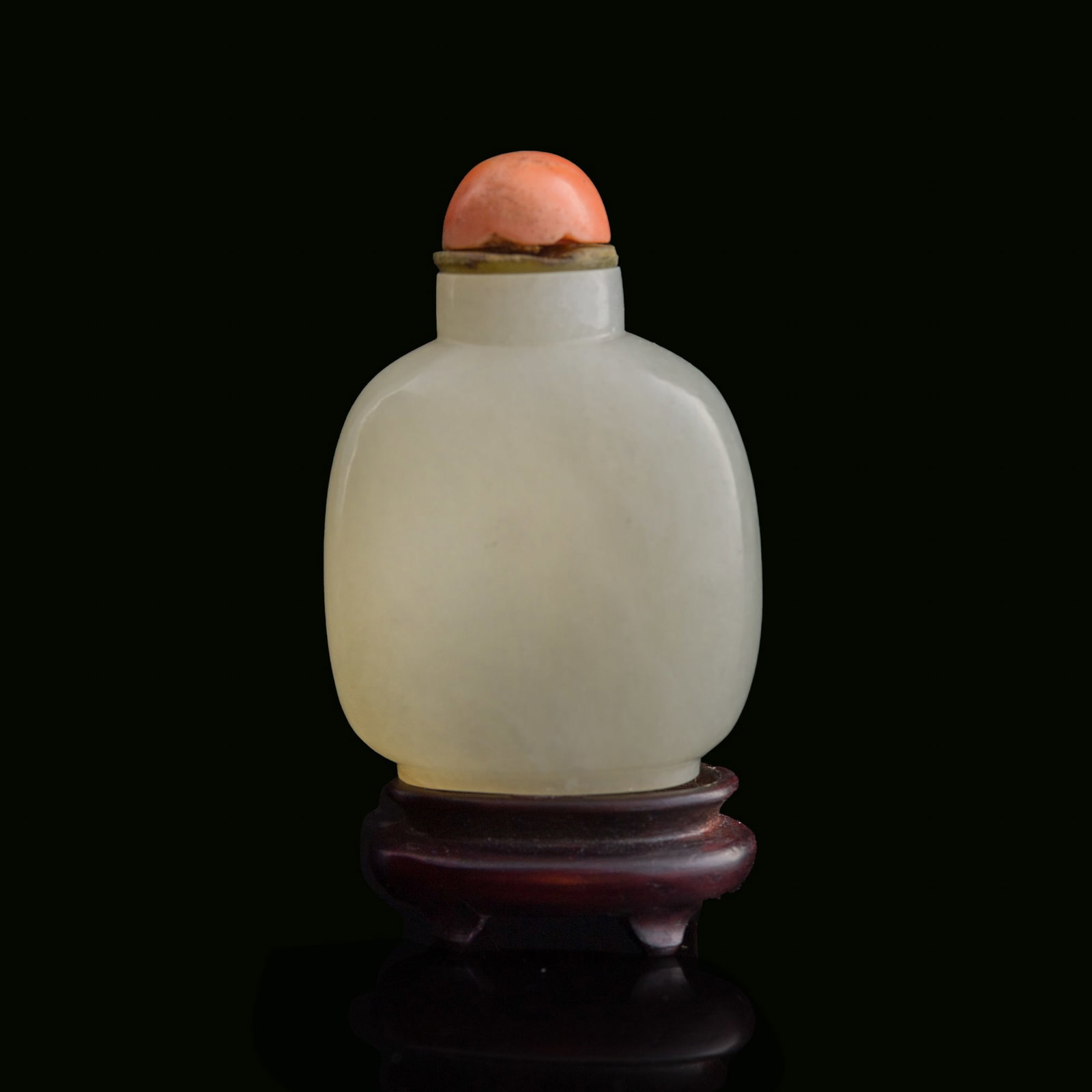 A Chinese white jade snuff bottle, 18th century: A Chinese white jade snuff bottle 18th century Sold with associated wooden stand. H: 3 1/8, W: 2 1/8, D: 1 1/4 in. (H: 7.9, W: 5.4, D: 3.2 cm. (snuff bottle)) From Mr. Chen, Great Neck, New York; acqu