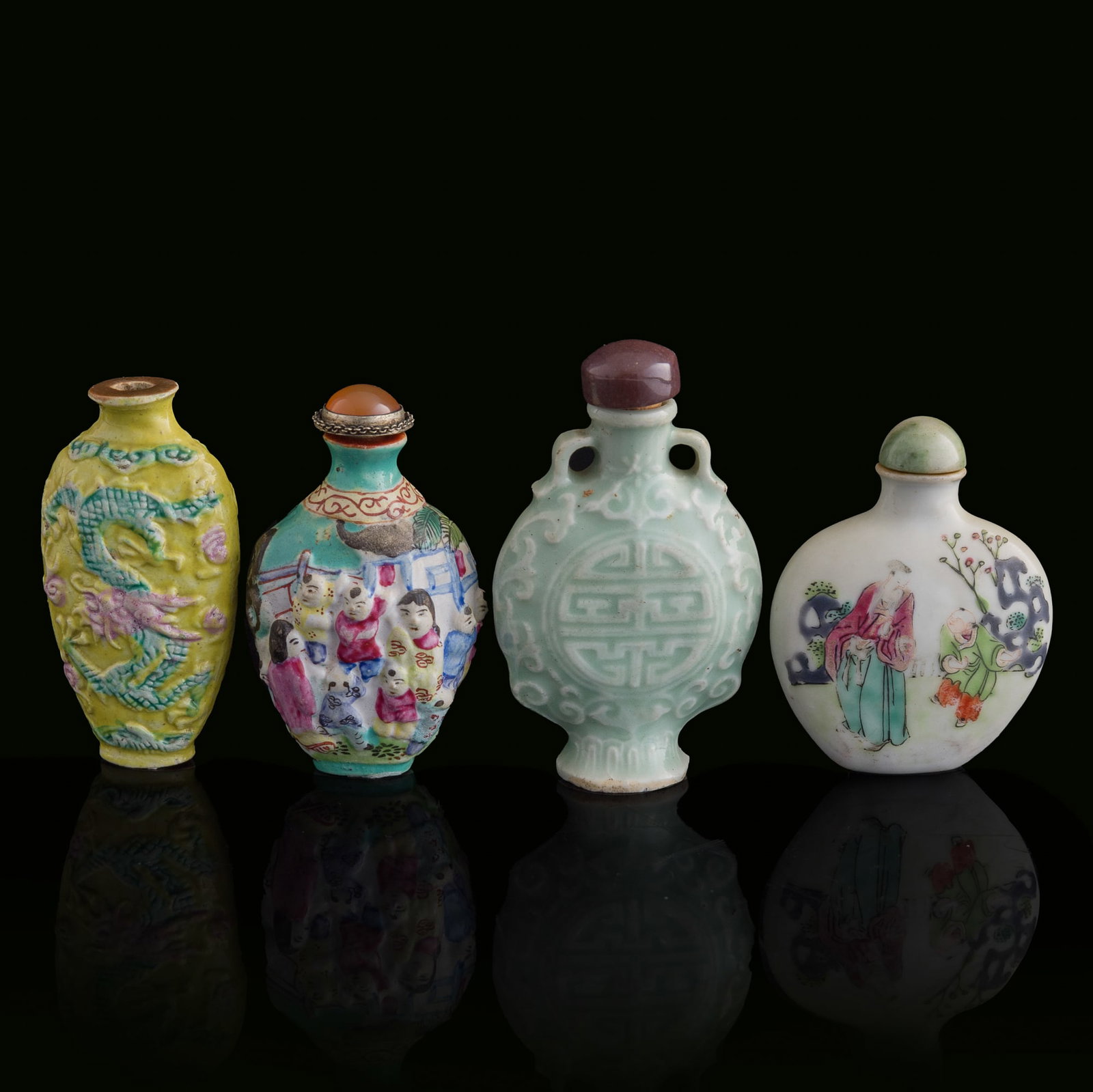 Four Chinese porcelain snuff bottles, Qing dynasty: Four Chinese porcelain snuff bottles Qing dynasty Comprising three famille rose snuff bottles and one celadon-glazed snuff bottle. (4). H: 3 1/2, W: 2 1/8, D: 7/8 in. (H: 8.9, W: 5.4, D: 2.2 cm. (cela
