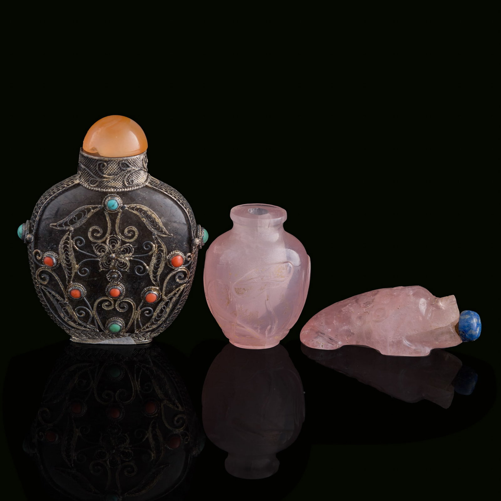 Three Chinese quartz snuff bottles, Qing dynasty/Republic period: Three Chinese quartz snuff bottles Qing dynasty/Republic period Comprising two rose quartz snuff bottles and one rutilated quartz snuff bottle. (3). H: 2 3/8, W: 2 1/4, D: 7/8 in. (H: 6, W: 5.7, D: 2.