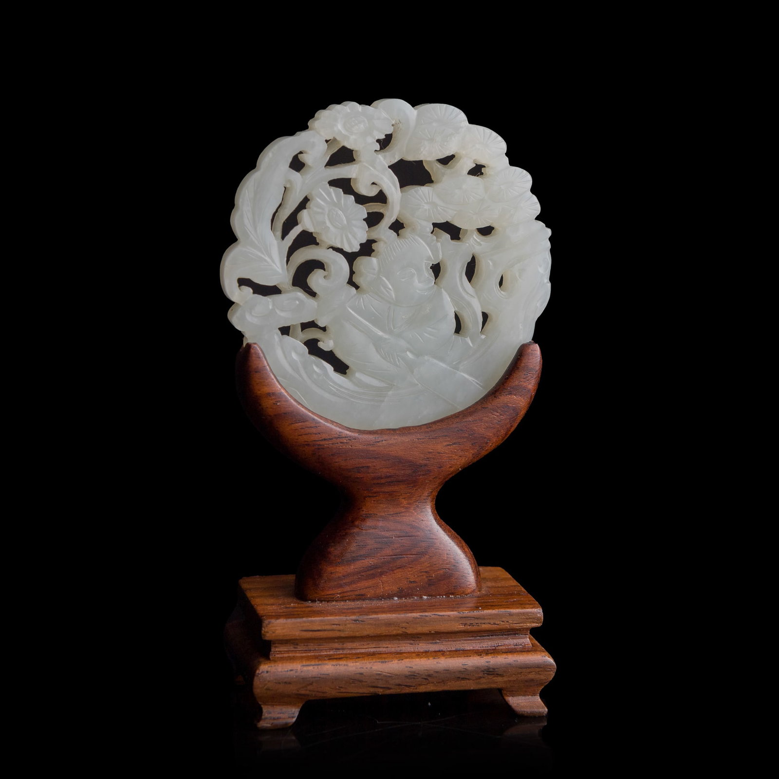 A Chinese reticulated white jade 'boy' plaque, early 19th century (1 of 9)