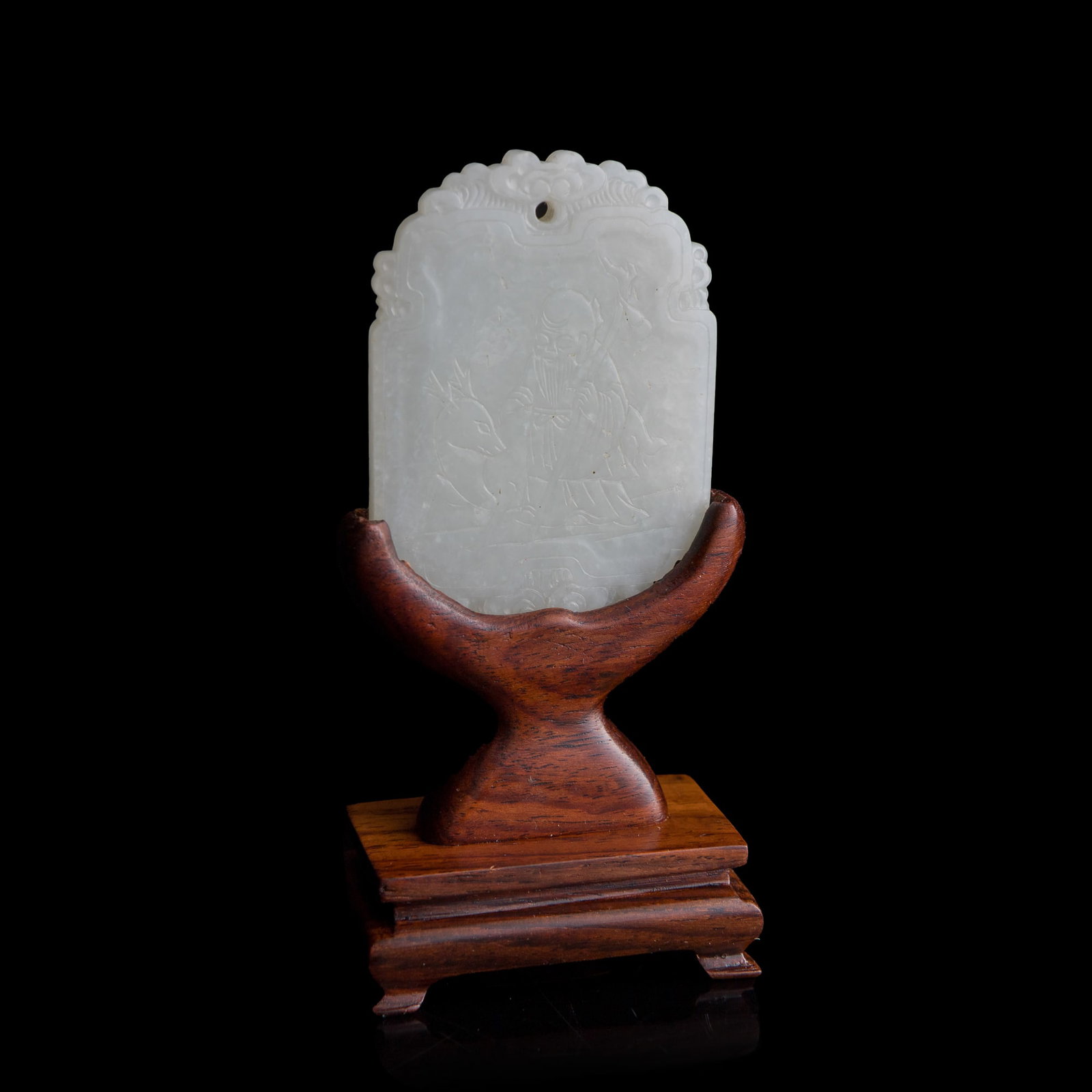 A Chinese carved white jade 'happiness' plaque, early 19th century: A Chinese carved white jade 'happiness' plaque early 19th century Sold with associated wooden stand. H: 2 3/8, W: 1 3/4, D: 3/16 in. (H: 6, W: 4.4, D: 0.5 cm. (jade)) From Mr. Tinero, Calabasas,