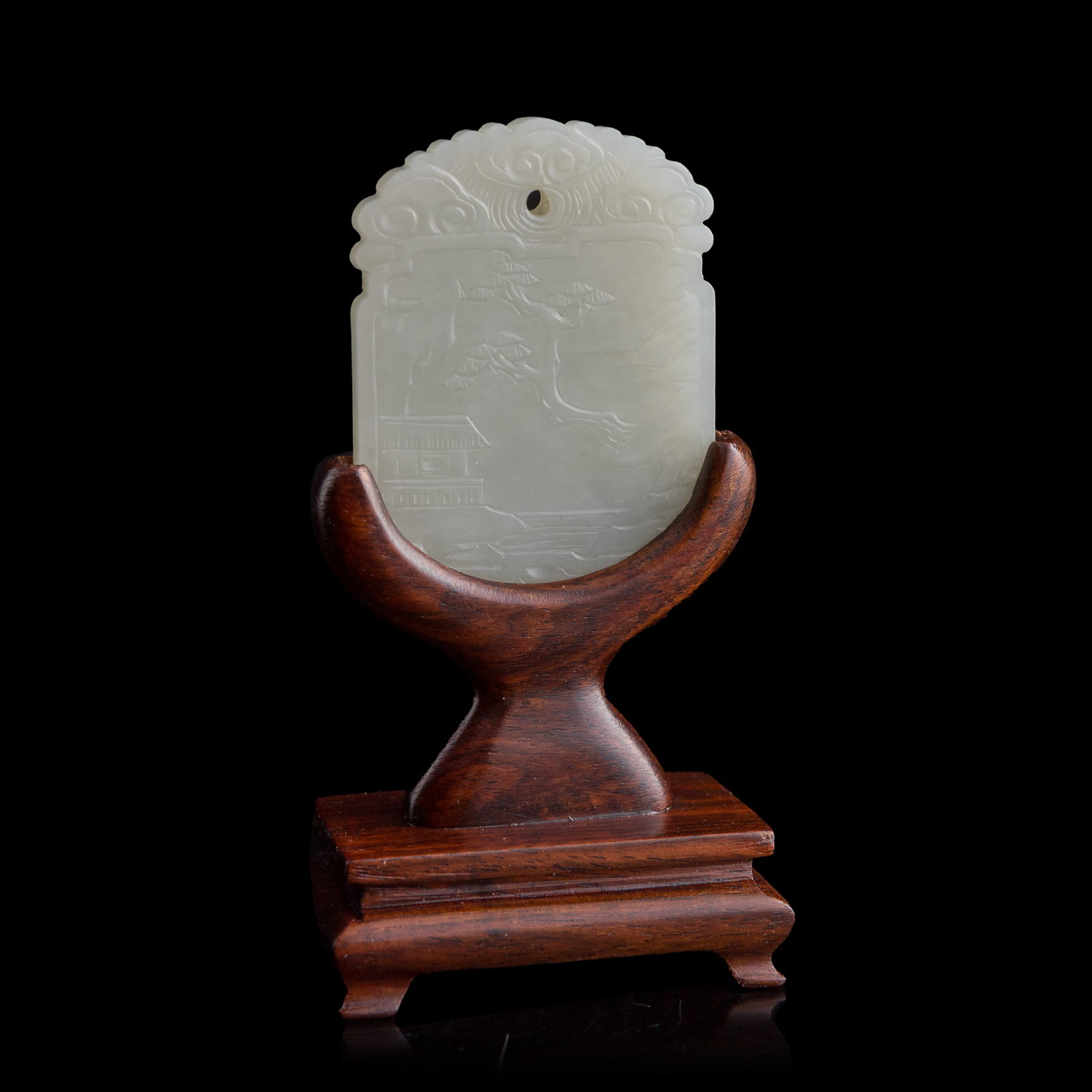 A Chinese carved white jade 'landscape' plaque, early 19th century: A Chinese carved white jade 'landscape' plaque early 19th century Sold with associated wooden stand. H: 2 1/8, W: 1 5/8, D: 3/16 in. (H: 5.4, W: 4.1, D: 0.5 cm. (jade)) From Mr. Tinero, Calabasas,
