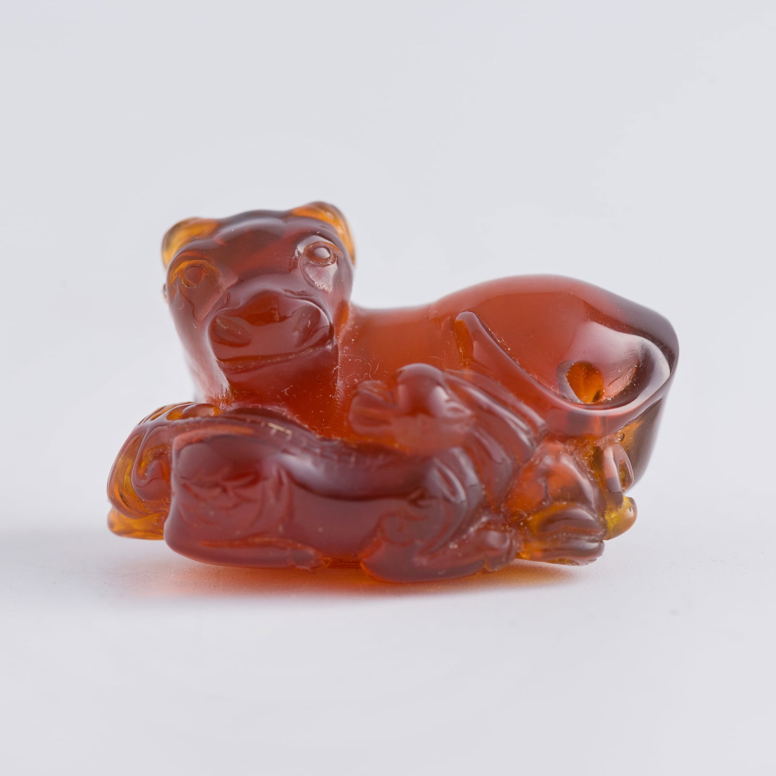 A Chinese amber pendant of a cow and a calf, 19th century: A Chinese amber pendant of a cow and a calf 19th century Sold with associated fitted box. H: 1 1/2, W: 1 1/8, D: 1 in. (H: 3.8, W: 2.9, D: 2.5 cm.) Weight: 13 g From Mrs. Kiang in Newport Coast, Calif