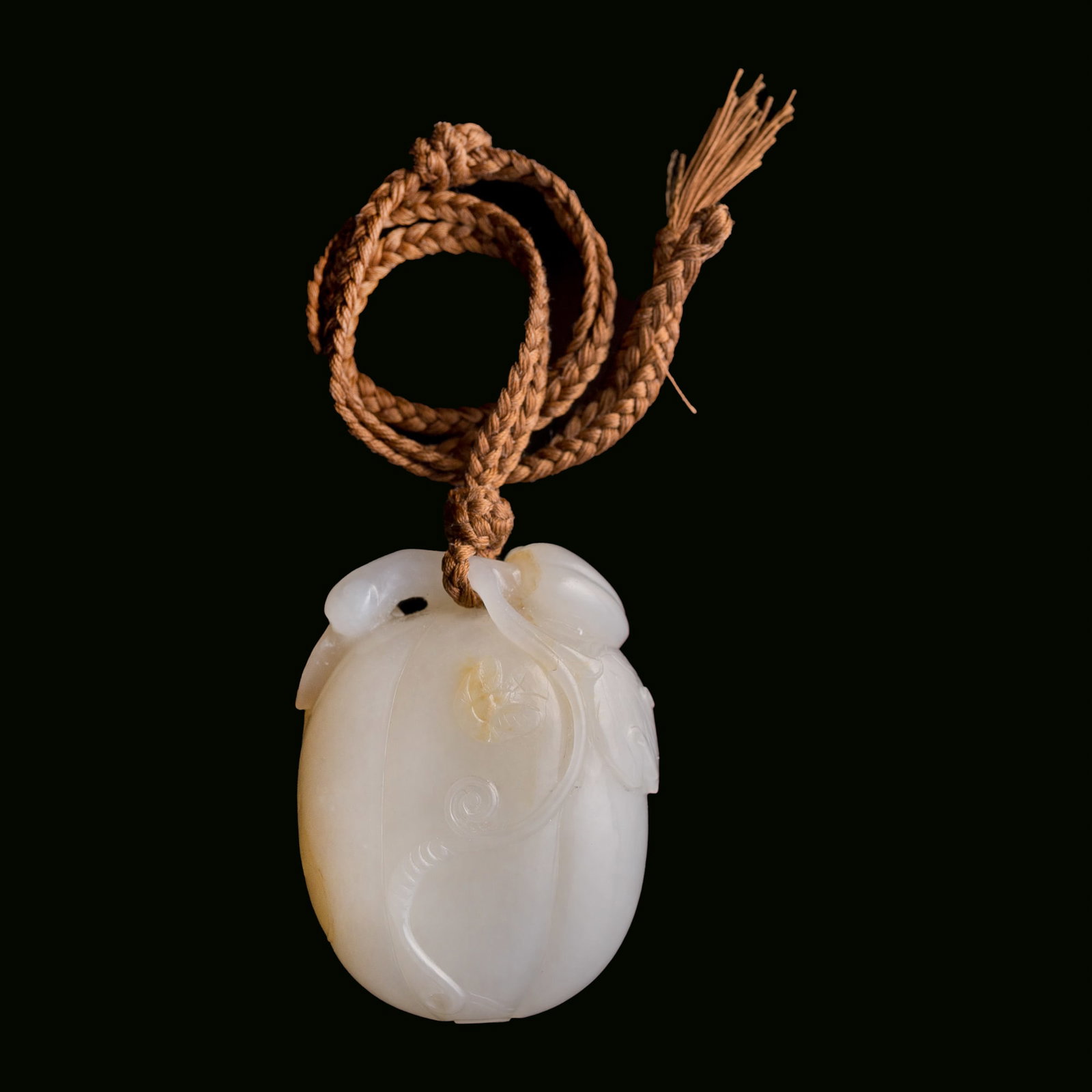 A Chinese white jade pendant of melons with russet skin, 18th century: A Chinese white jade pendant of melons with russet skin 18th century H: 2, W: 1 1/2, D: 7/8 in. (H: 5.1, W: 3.8, D: 2.2 cm.) From Mrs. Kiang in Newport Coast, California; collected by her late