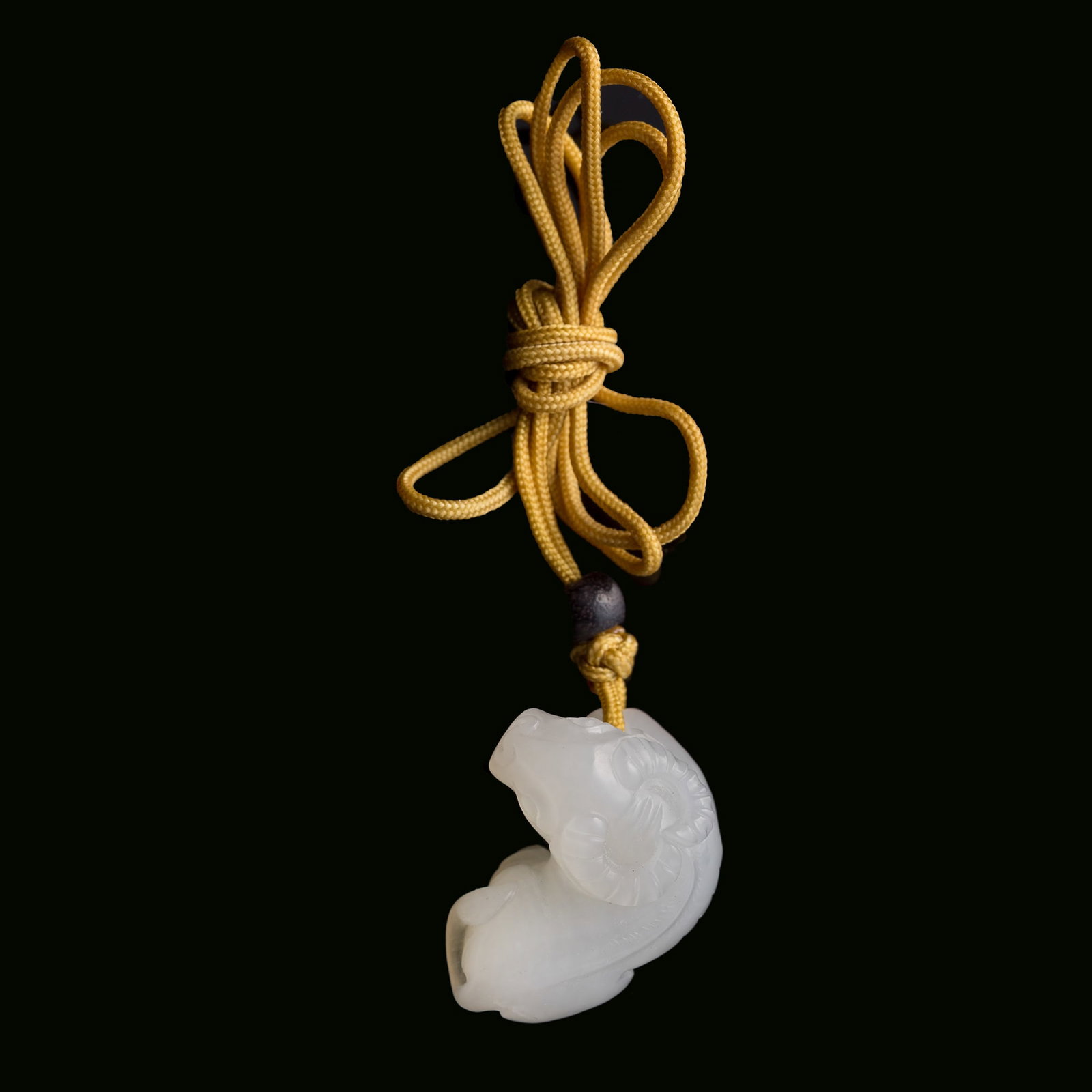 A Chinese carved white jade pendant of a recumbent ox, 19th century: A Chinese carved white jade pendant of a recumbent ox 19th century H: 3/4, W: 1 1/4, D: 1 in. (H: 1.9, W: 3.2, D: 2.5 cm.) From Mrs. Kiang in Newport Coast, California; collected by her late husband.