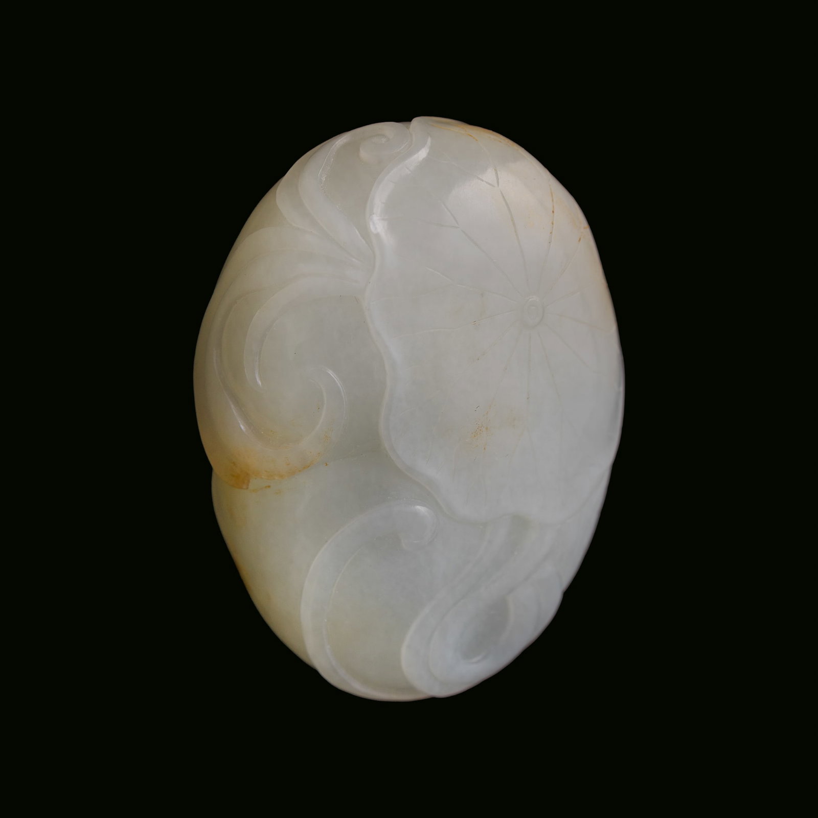 A Chinese carved white jade carving of a lotus pod, 18th/19th century: A Chinese carved white jade carving of a lotus pod 18th/19th century H: 1 1/2, W: 2, D: 7/8 in. (H: 3.8, W: 5.1, D: 2.2 cm.) From Mrs. Kiang in Newport Coast, California; collected by her late