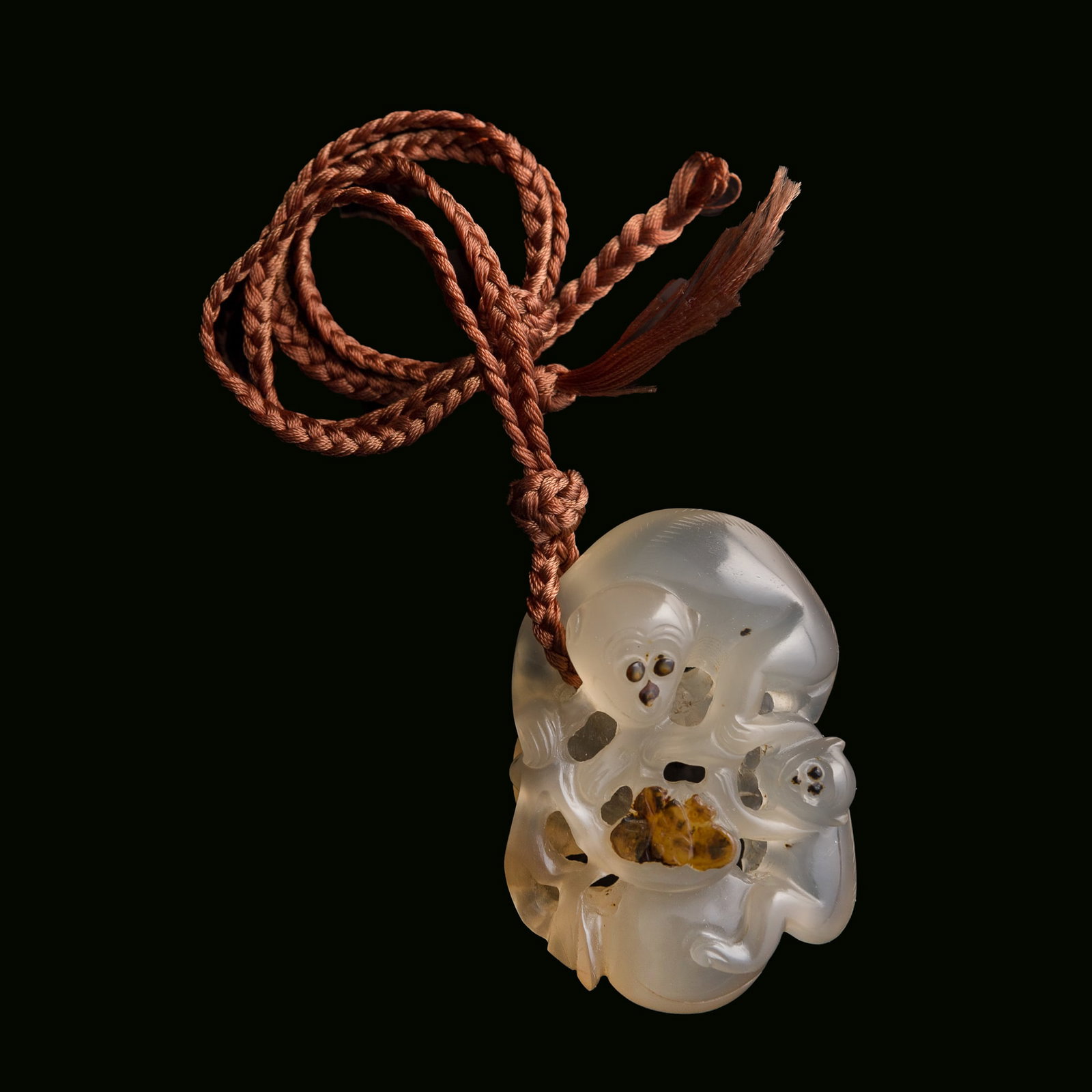 A Chinese agate 'monkey' and 'peach' pendant, Qing dynasty: A Chinese agate 'monkey' and 'peach' pendant Qing dynasty H: 1 1/2, W: 2, D: 7/8 in. (H: 3.8, W: 5.1, D: 2.2 cm.) From Mrs. Kiang in Newport Coast, California; collected by her late husband. Click