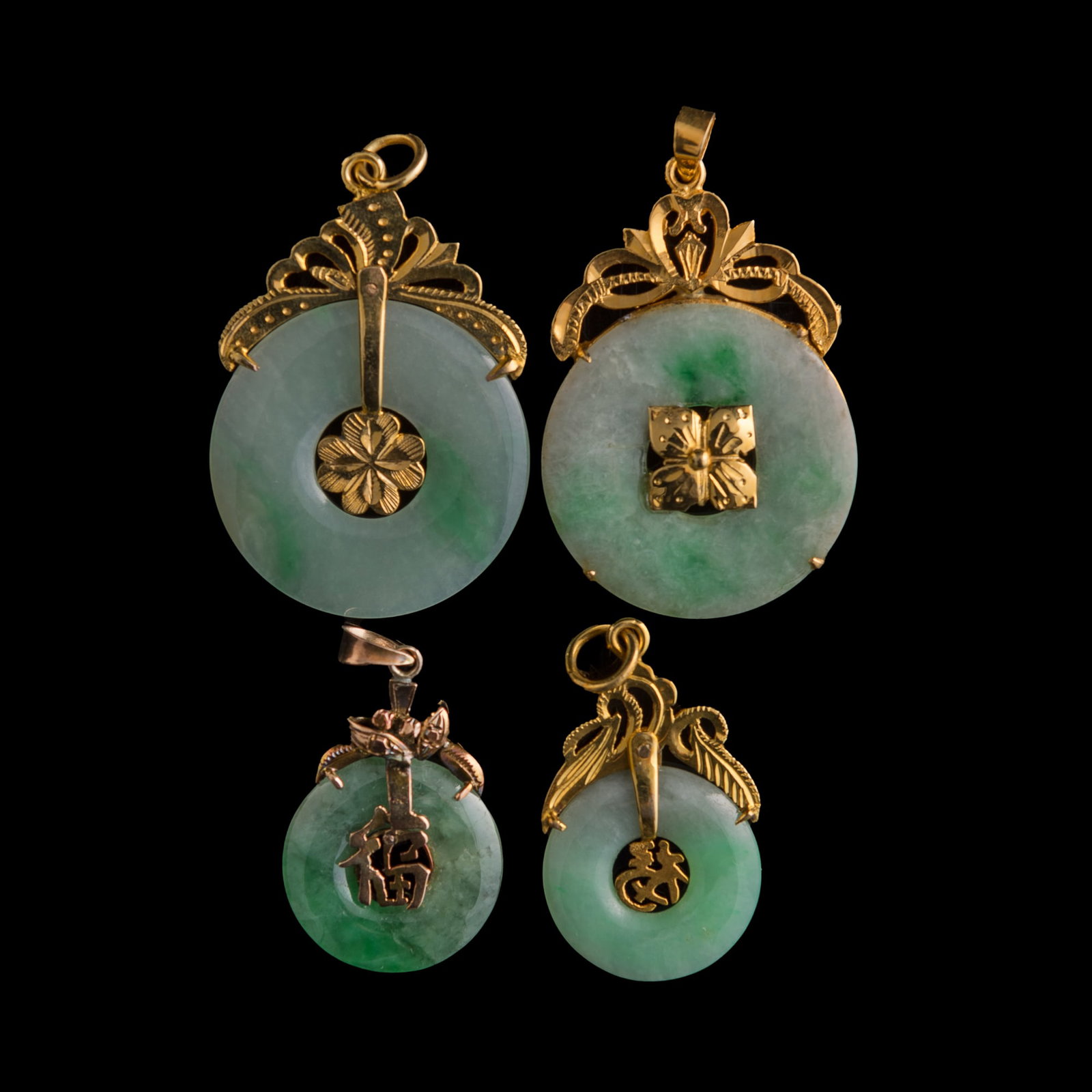 Four Chinese jadeite bi-disc with metal mounts: Four Chinese jadeite bi-disc with metal mounts One with "14K" stamp mark to bail. (4). H: 35.2, W: 26.5 mm (largest) From Mrs. Ong in Huntington Beach, California. Click here for high resolution