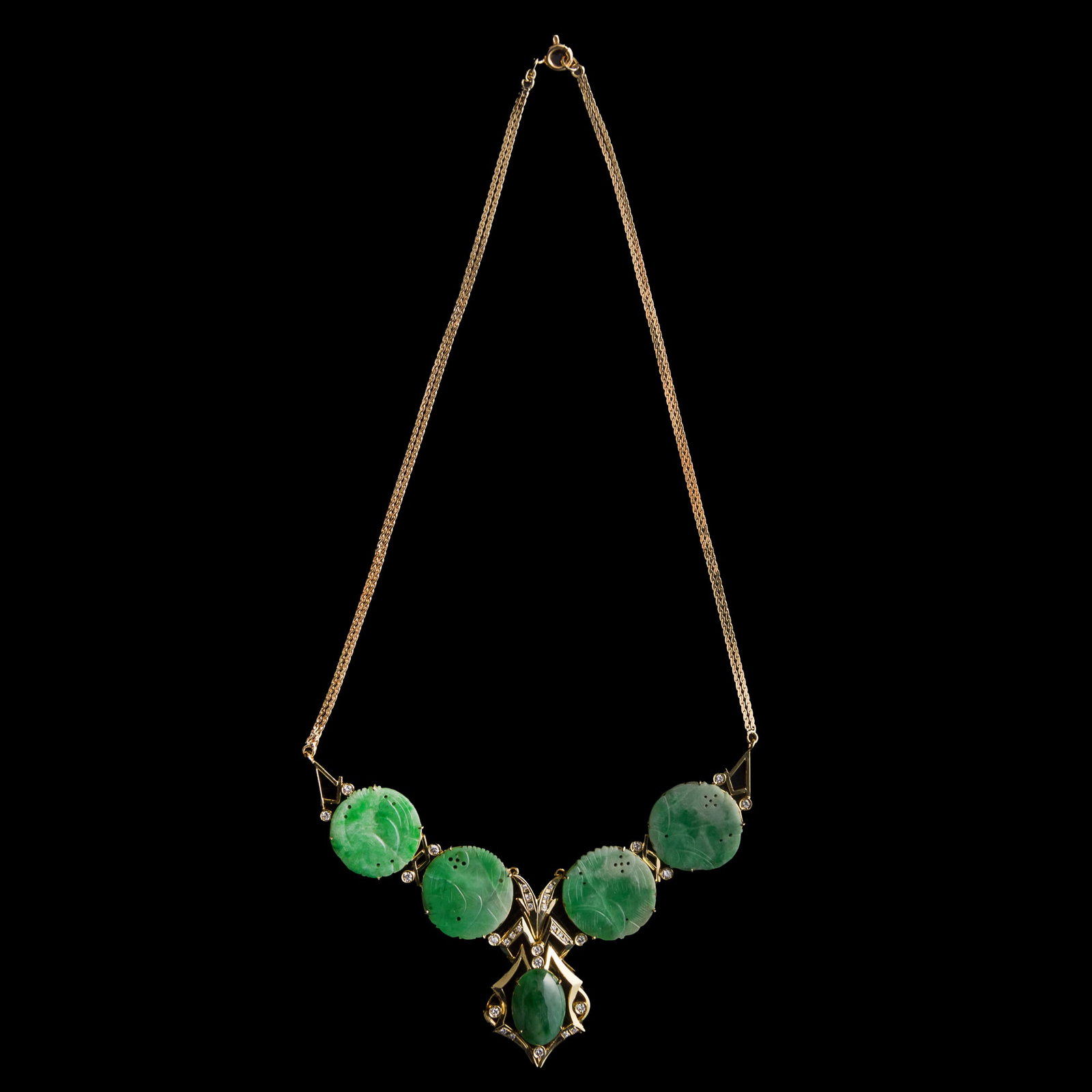 A Chinese metal and jadeite necklace: A Chinese metal and jadeite necklace With "585" stamp mark to the clasp. L: 8 1/4, W: 3 1/2 in. (L: 21, W: 8.9 cm.) Jadeite: Dia: 19.2 mm (largest) Weight: 19.04 g From Mrs. Ong in Huntington Beach,