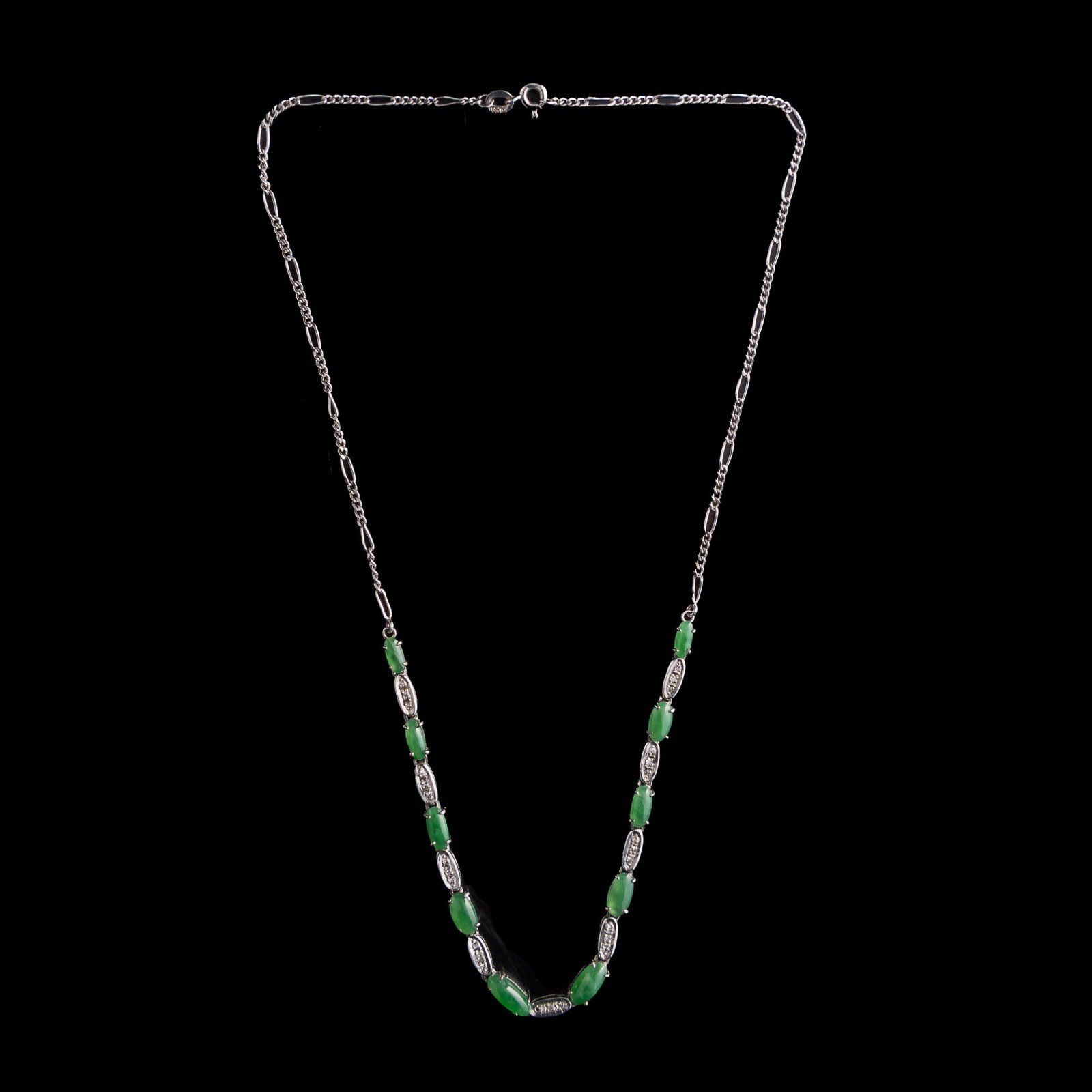 A Chinese jadeite-set white metal necklace: A Chinese jadeite-set white metal necklace With a stamp mark to the clasp. L: 8 in. (20.3 cm.) Jadeite: H: 4.1, W: 9.6 mm (largest) Weight: 8.1 g From Mrs. Ong in Huntington Beach, California.