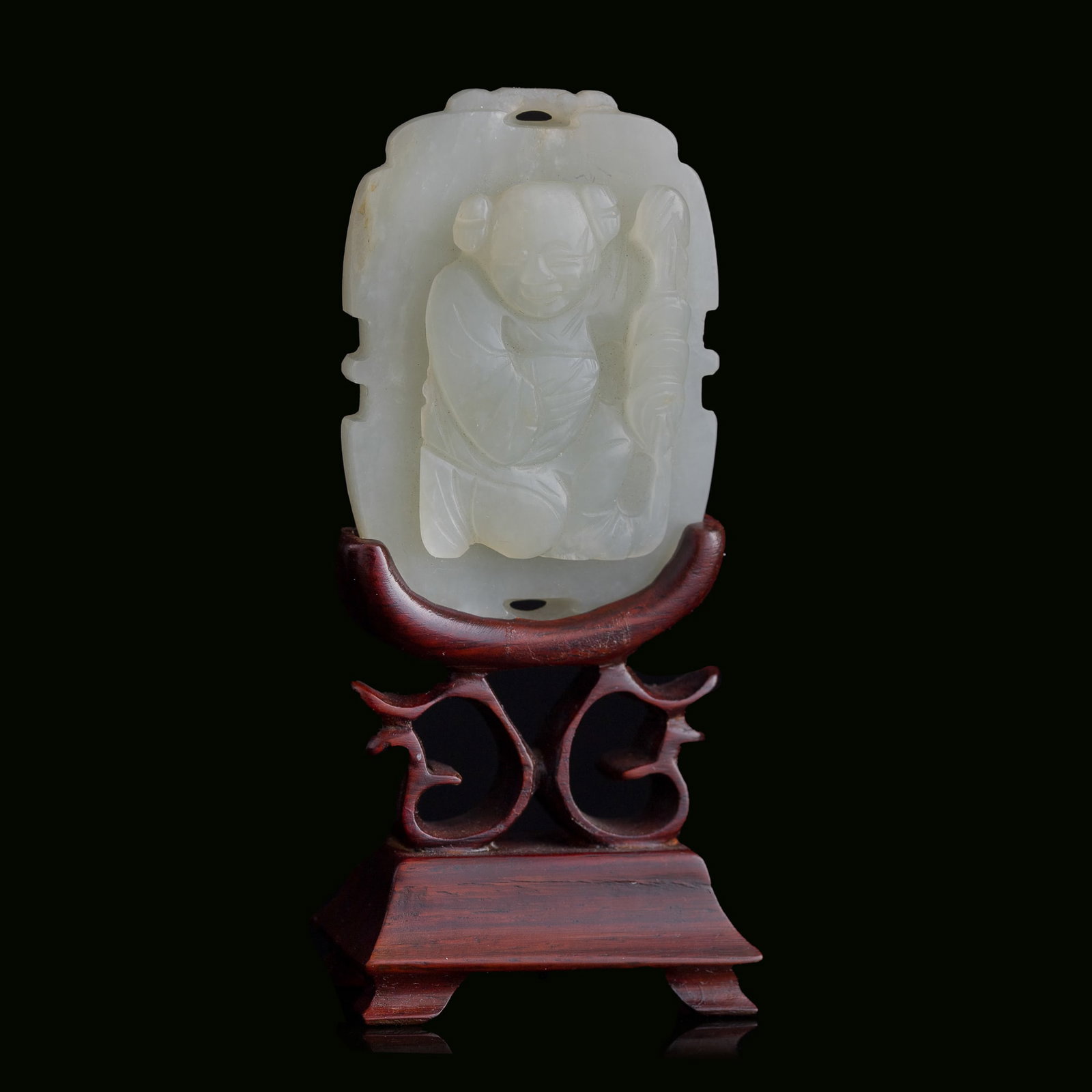 A Chinese carved white jade 'boy and lotus' pendant, 19th century: A Chinese carved white jade 'boy and lotus' pendant 19th century Sold with associated wooden stand. H: 2 3/8, W: 1 5/8, D: 3/8 in. (H: 6, W: 4.1, D: 1 cm. (pendant)) From Mr. Chen, Great Neck, New Yor