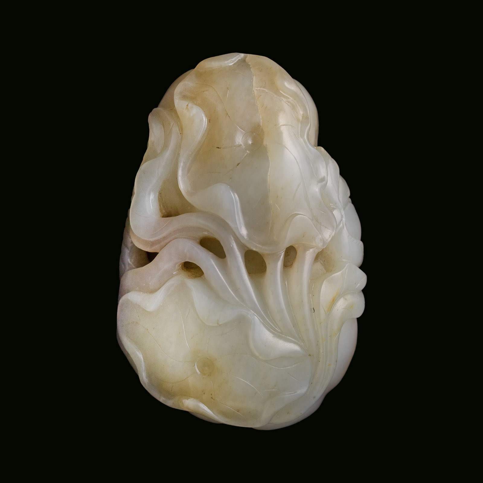A Chinese carved white jade pendant with russet skin, Qianlong period, Qing dynasty: A Chinese carved white jade pendant with russet skin Qianlong period, Qing dynasty Carved as a group of lotus pods, leaves, and blossoms, with a dragonfly. H: 1 3/4, W: 2 5/8, D: 1 1/8 in. (H: 4.4, W:
