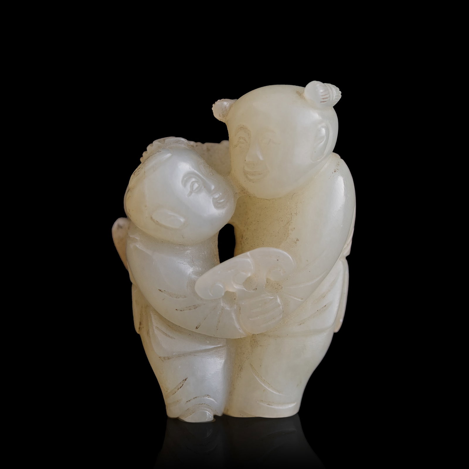 A Chinese white jade carving of two boys, 18th/19th century: A Chinese white jade carving of two boys 18th/19th century H: 1 1/2, W: 1 1/8, D: 3/4 in. (H: 3.8, W: 2.9, D: 1.9 cm.) Private collection, Southern California.