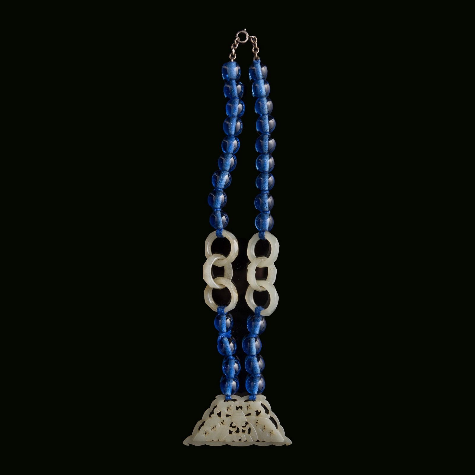 A Chinese necklace composed of glass beads, jade rings and jade pendant, 19th century: A Chinese necklace composed of glass beads, jade rings and jade pendant 19th century L: 8 1/2 in. (21.6 cm.) Pendant: H: 1 1/8, W: 2 3/8, D: 1/8 in. (H: 2.9, W: 6, D: 0.3 cm.) From Mr. Kaufman in Arli