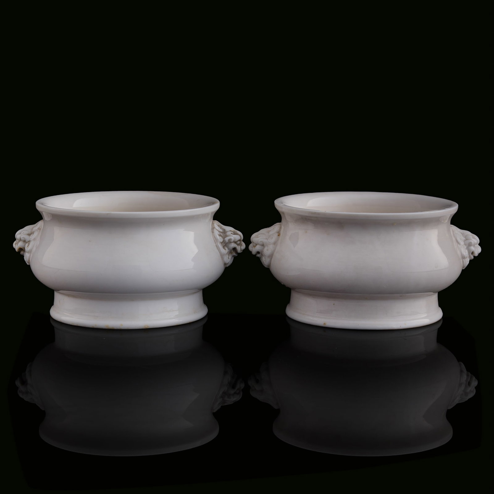 A pair of Chinese Dehua censers with beast handles, 18th century: A pair of Chinese Dehua censers with beast handles 18th century Each with four-character mark to underside. (2). H: 3, W: 6 1/8, D: 5 1/4 in. (H: 7.6, W: 15.6, D: 13.3 cm. (each)) Private collection, 