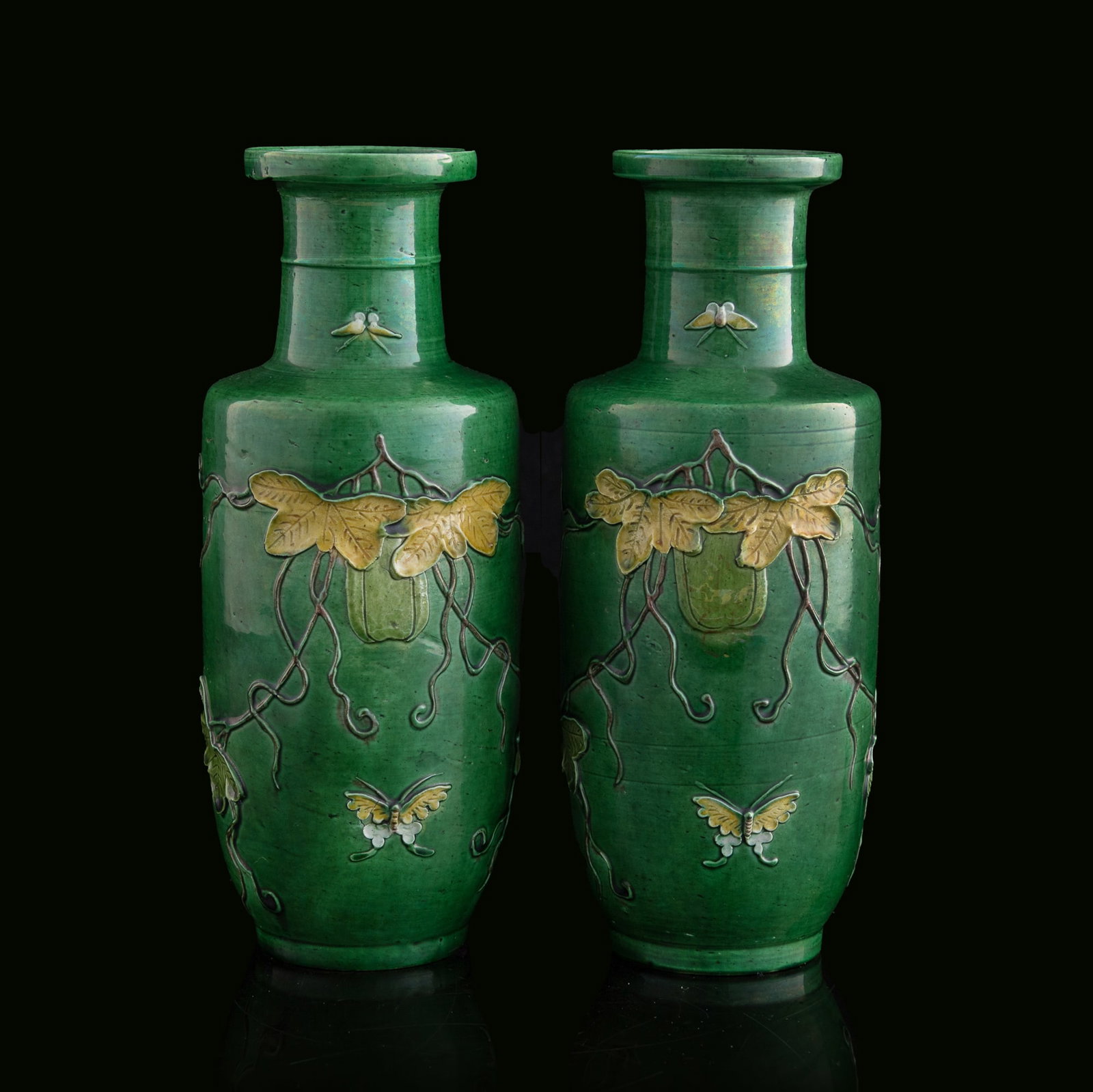 A pair of Chinese green-ground sancai rouleau vases, Republic period: A pair of Chinese green-ground sancai rouleau vases Republic period H: 9, Dia: 3 3/4 in. (H: 22.9, Dia: 9.5 cm. (each)) Private collection, Pennsylvania.
